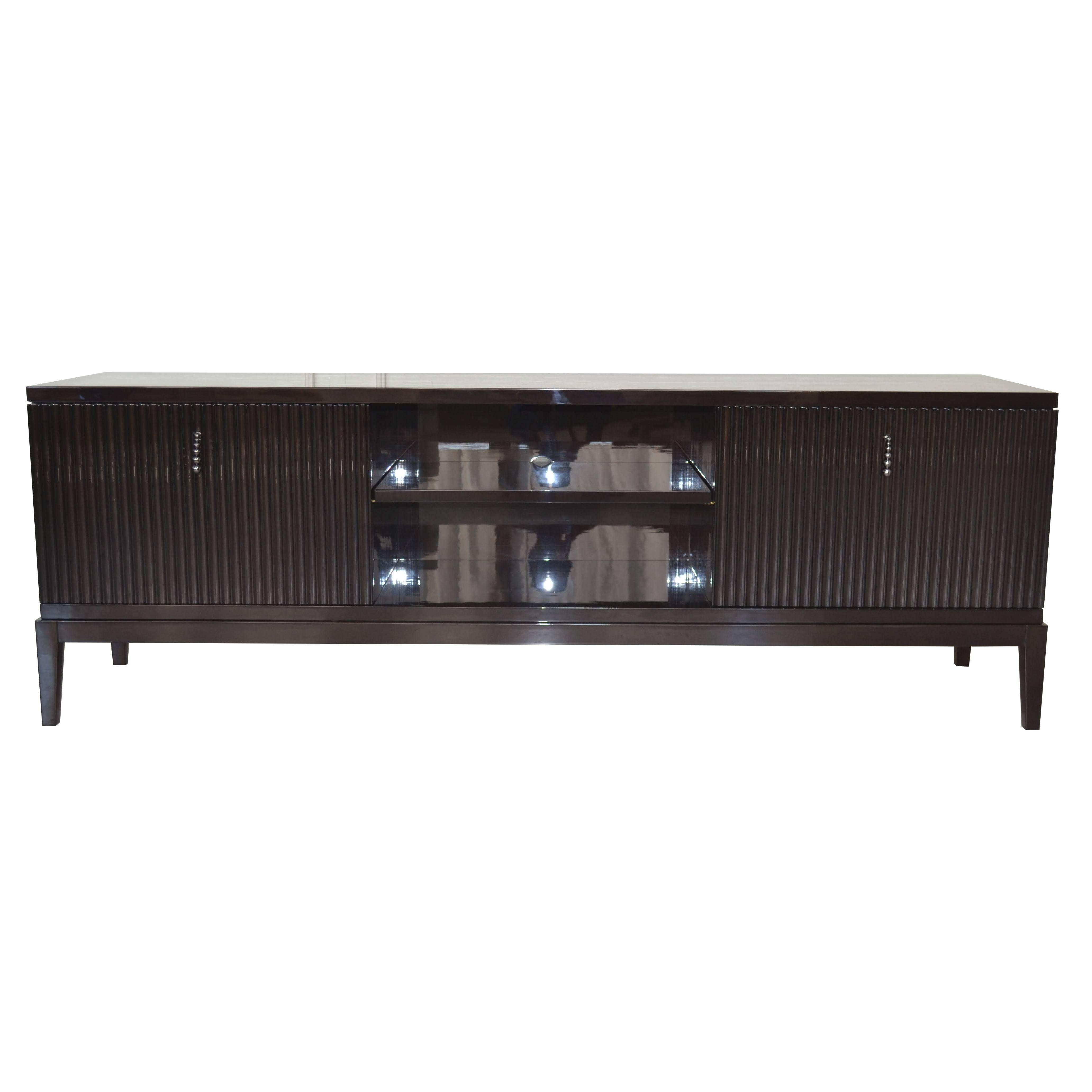 Laquered in brown high-gloss is an outstanding piece in living room. Elegant and contemporary with four legs in Ebano Lucido Scuro. Also it has two internal upholstered faux nubuk drawers. Ideally for as a TV stand.