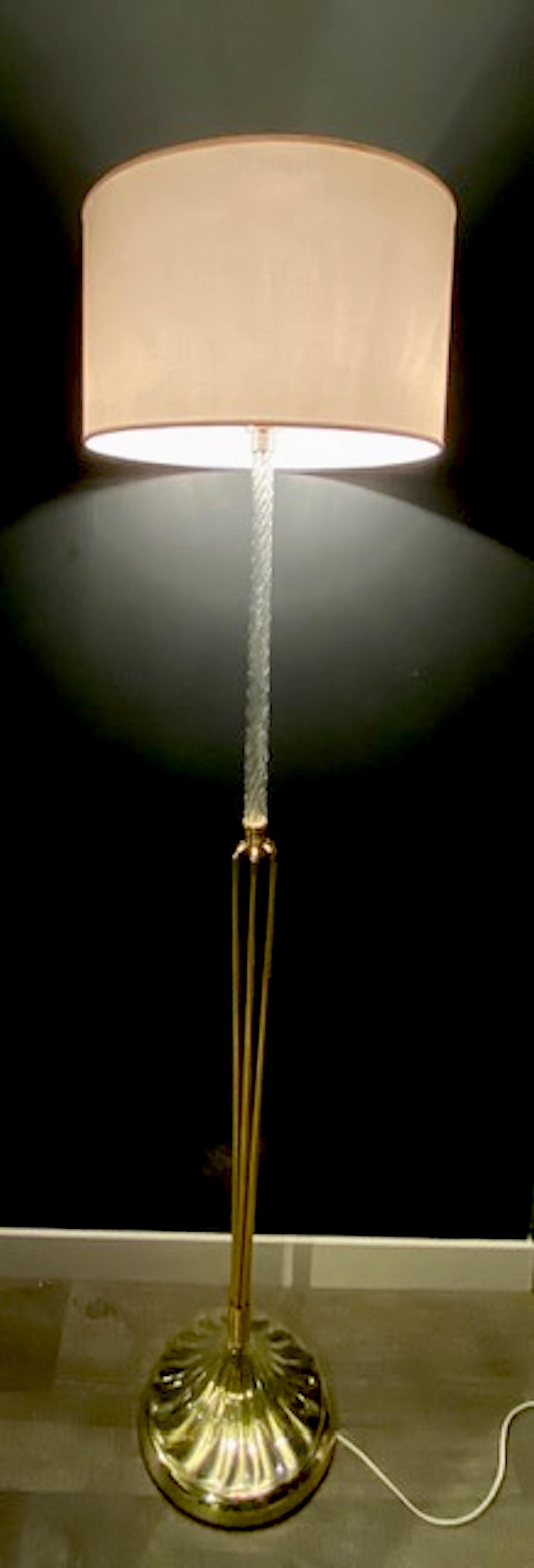 A truly stunning, unique and beautiful design is this exceptional Italian floor lamp made of Murano glass and brass. The top portion of the lamp is a hand twisted glass cane. The glass cane, in turn, sits into a small cap where six individual brass