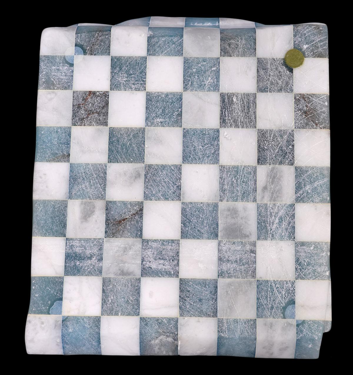 This Italian marble sculpture in the manner of Alasdair Thomson, a Scottish contemporary artist trained in Italy, is sculpted in the shape of a folded checkered men’s shirt. It is remarkable how the rigid marble has been transformed into what looks