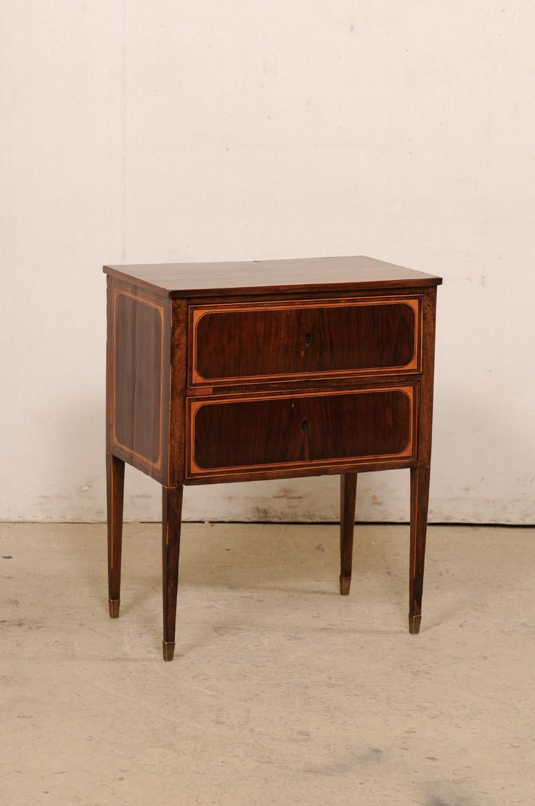 An Italian raised side chest with drawers from the 19th century. This antique end table from Italy has been designed with very clean lines and minimalist feel. The rectangular-shaped case houses a pair of stacked drawers, has clean/liner skirting,