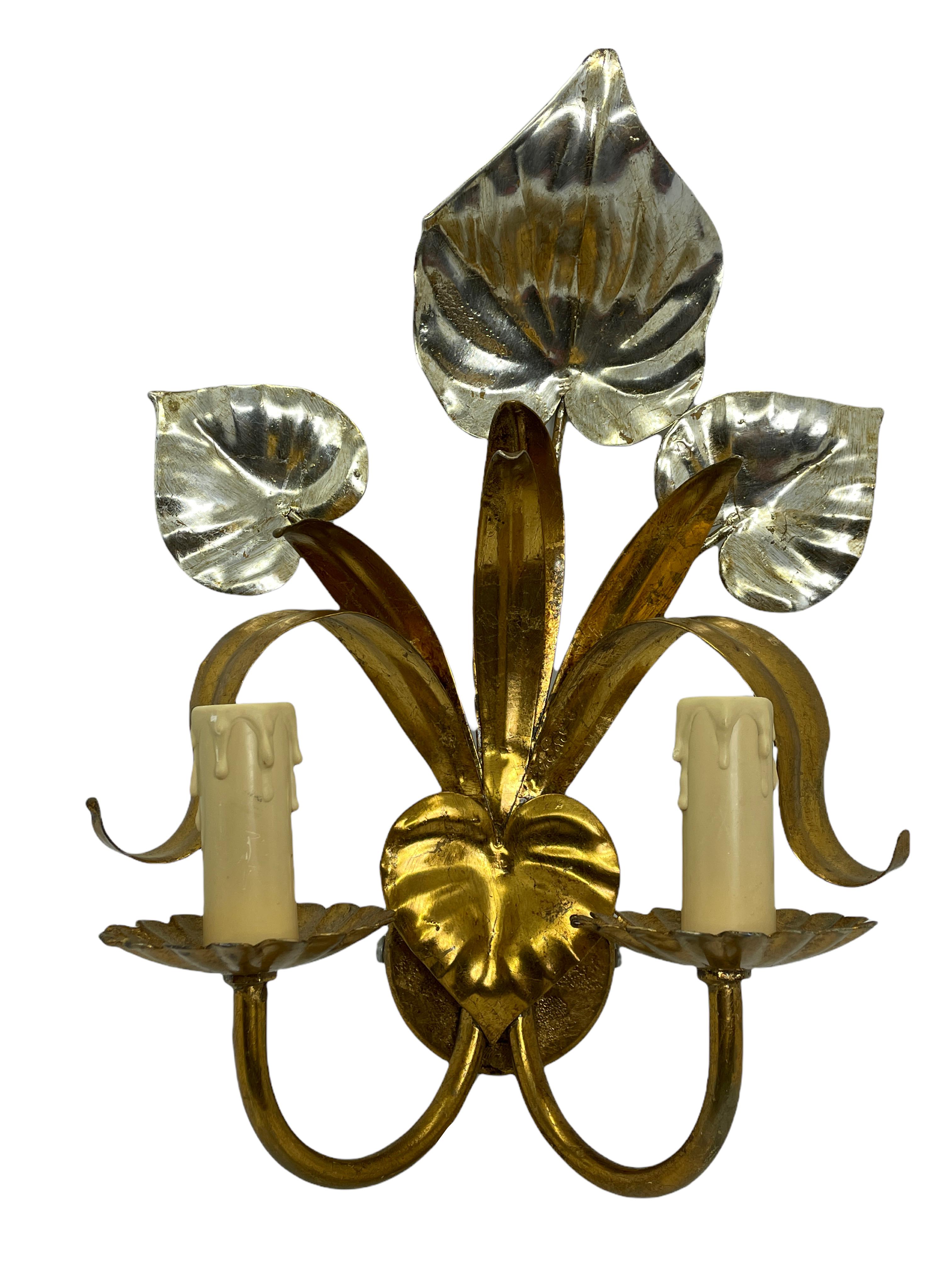 A Hollywood Regency midcentury gilt tolesconce, the fixture requires two European E14 candelabra bulbs, each bulb up to 40 watts. This wall light has a beautiful patina and gives each room an eclectic statement.