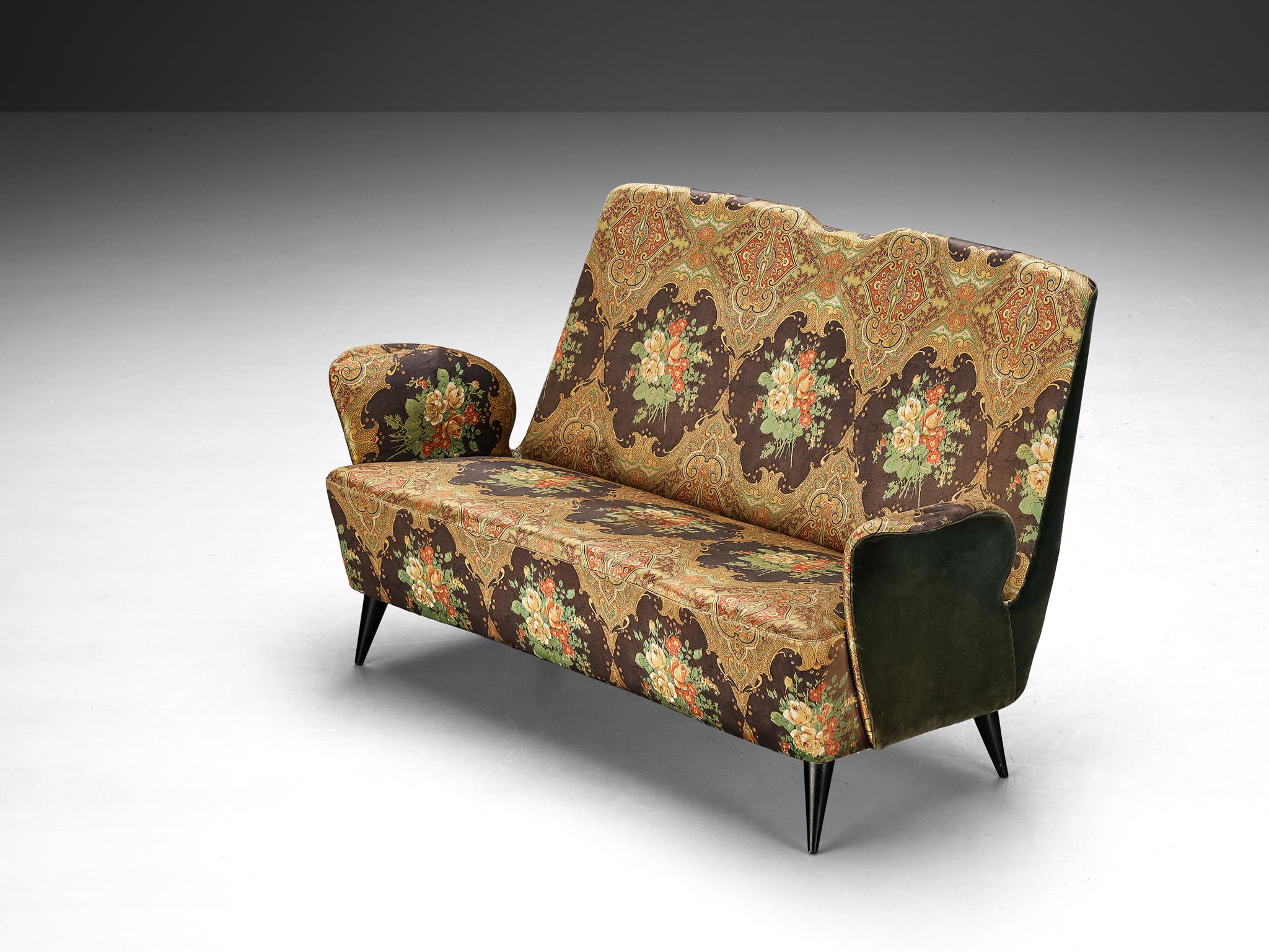 Sofa, fabric and wood, Italy, 1960s

Highly theatrical sofa that features curved, upsweeping armrests. This piece is made in Italy in the 1960s. The slightly tapered backrest is sculptural and theatrical. The titled, conical legs are made of black