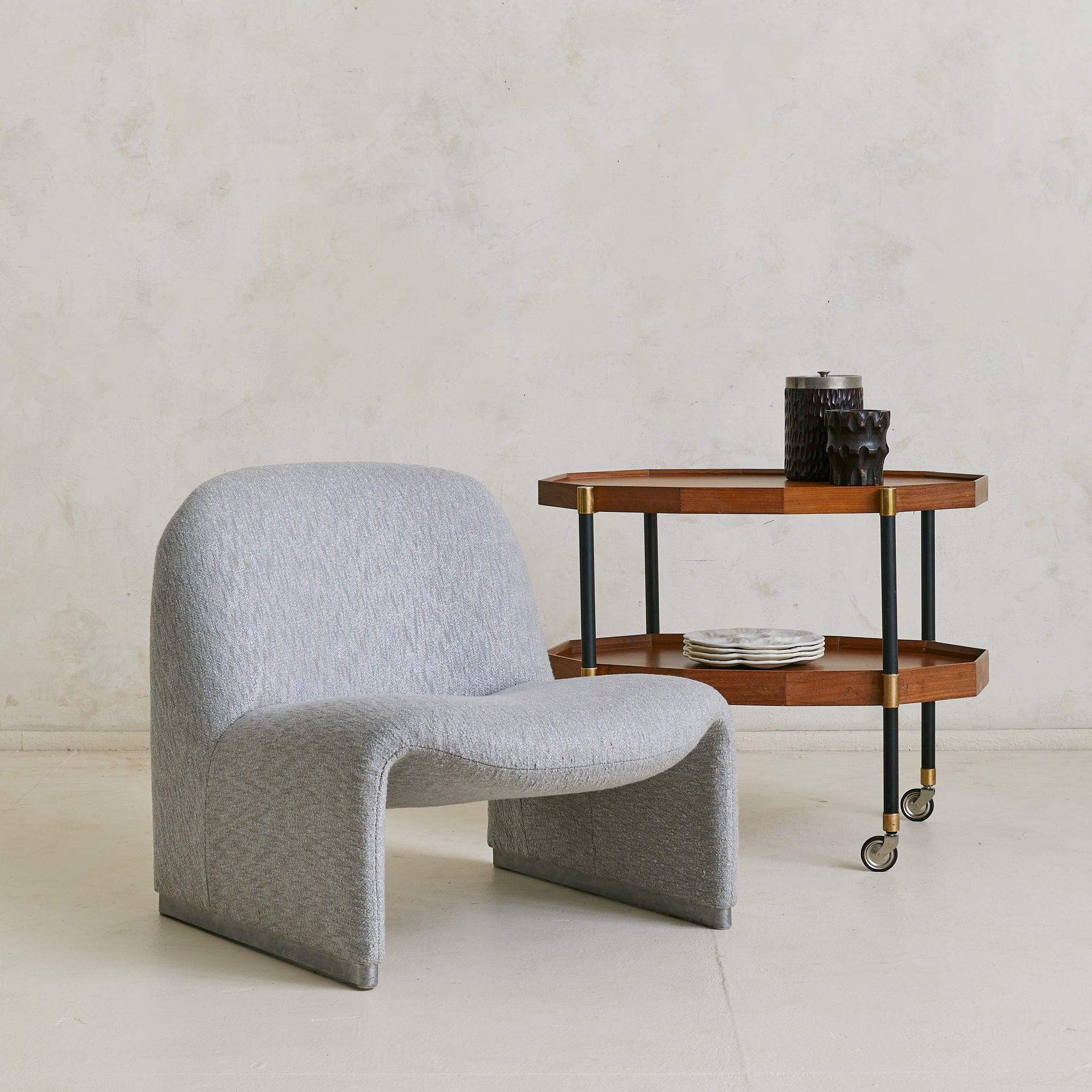 A versatile 1950s Italian bar cart, crafted in brass, wood, and metal. The octagonal trays are framed in warm-toned wood with raised edges and softly beveled corners. Slender black metal legs connect the two tiers, accented with brass collars and