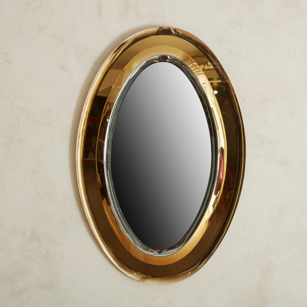 Italian two tone oval mirror in the style of Fontana Arte, 1960s.