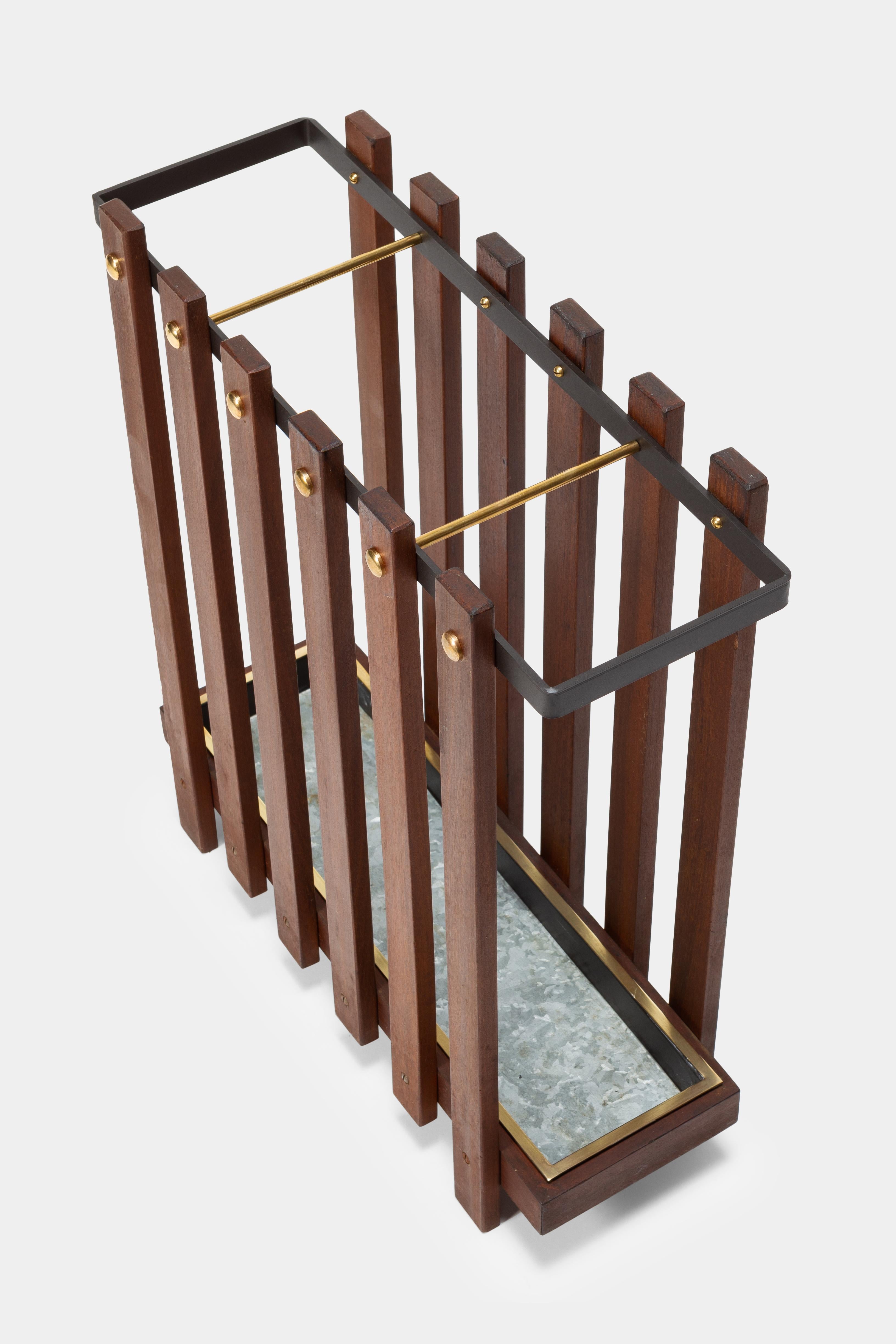 Customized umbrella stand manufactured in the 1960s in Italy. Solid mahogany wood with elegant brass details attached to a black lacquered metal frame.