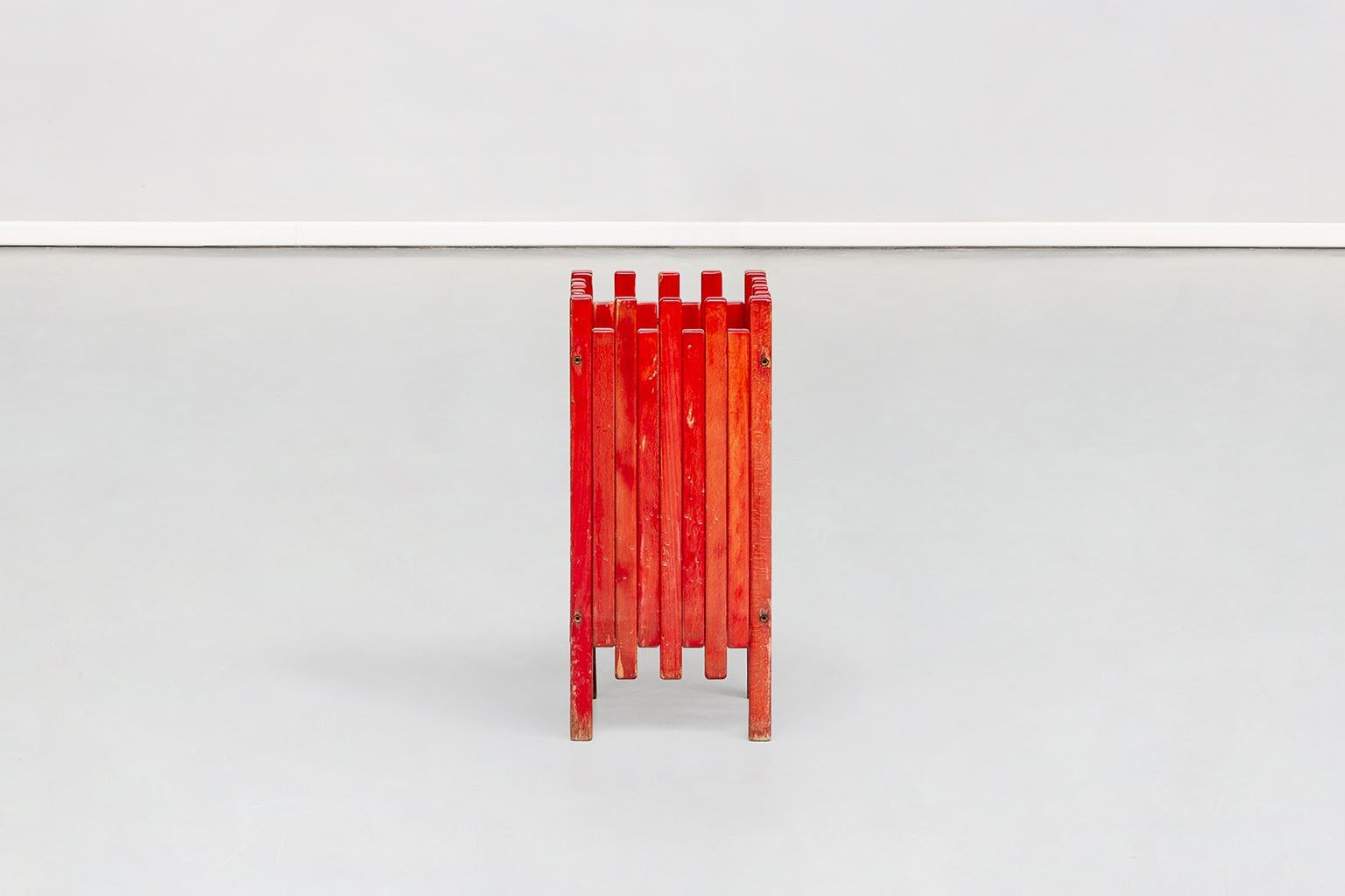Italian umbrella-stand in red painted wood, designed by Ettore Sottsass for Poltronova in 1962; the umbrella-stand takes up the unique style of Ettore Sottsass, that is linear, minimal and geometrical. The wood axes of different heights enlive and