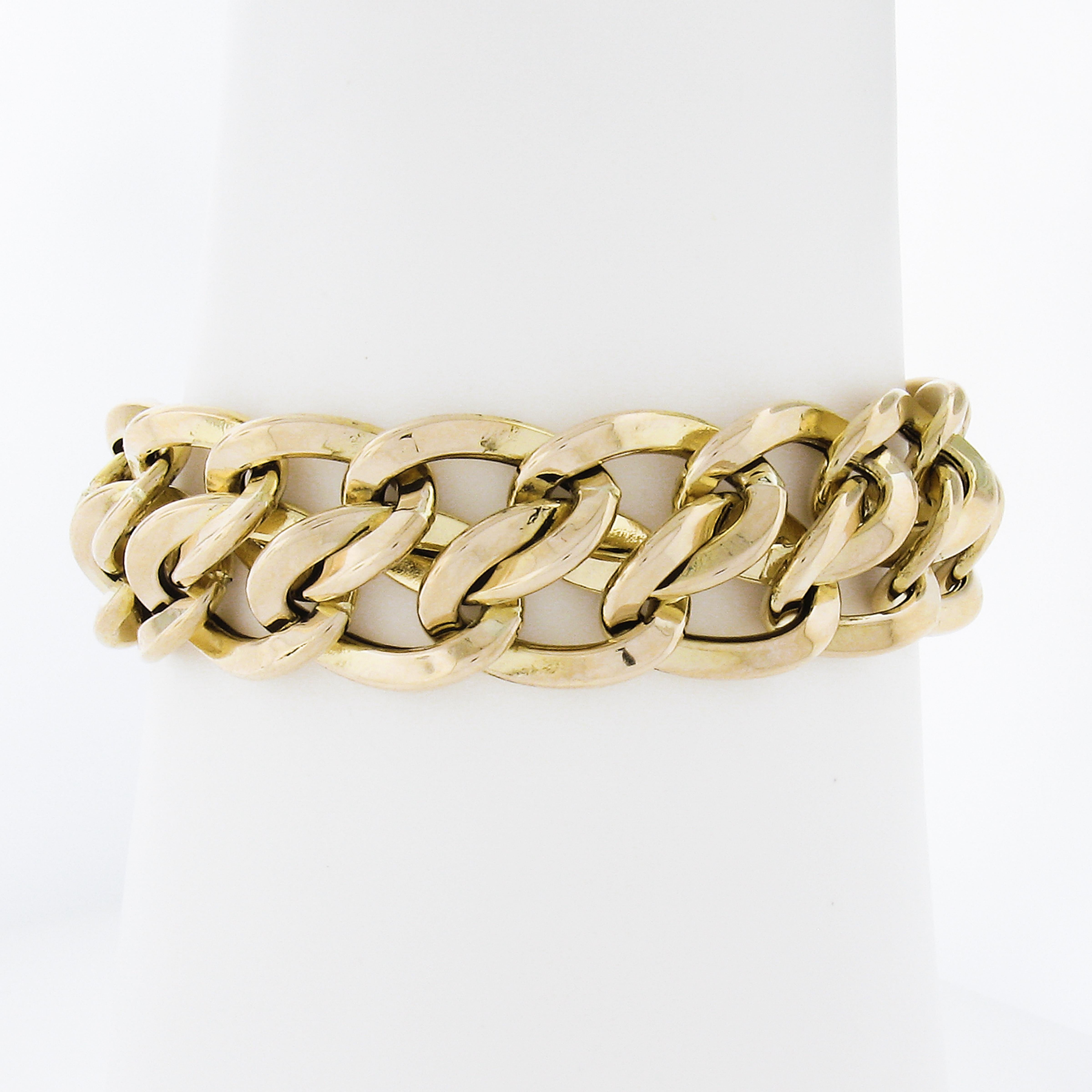 This Italian UnoAErre interlocking link statement chain bracelet is crafted from solid 14k yellow gold. It features a wide polished finish elegant design. The bracelet is in excellent condition! A substantial look on the wrist. Hollow design but
