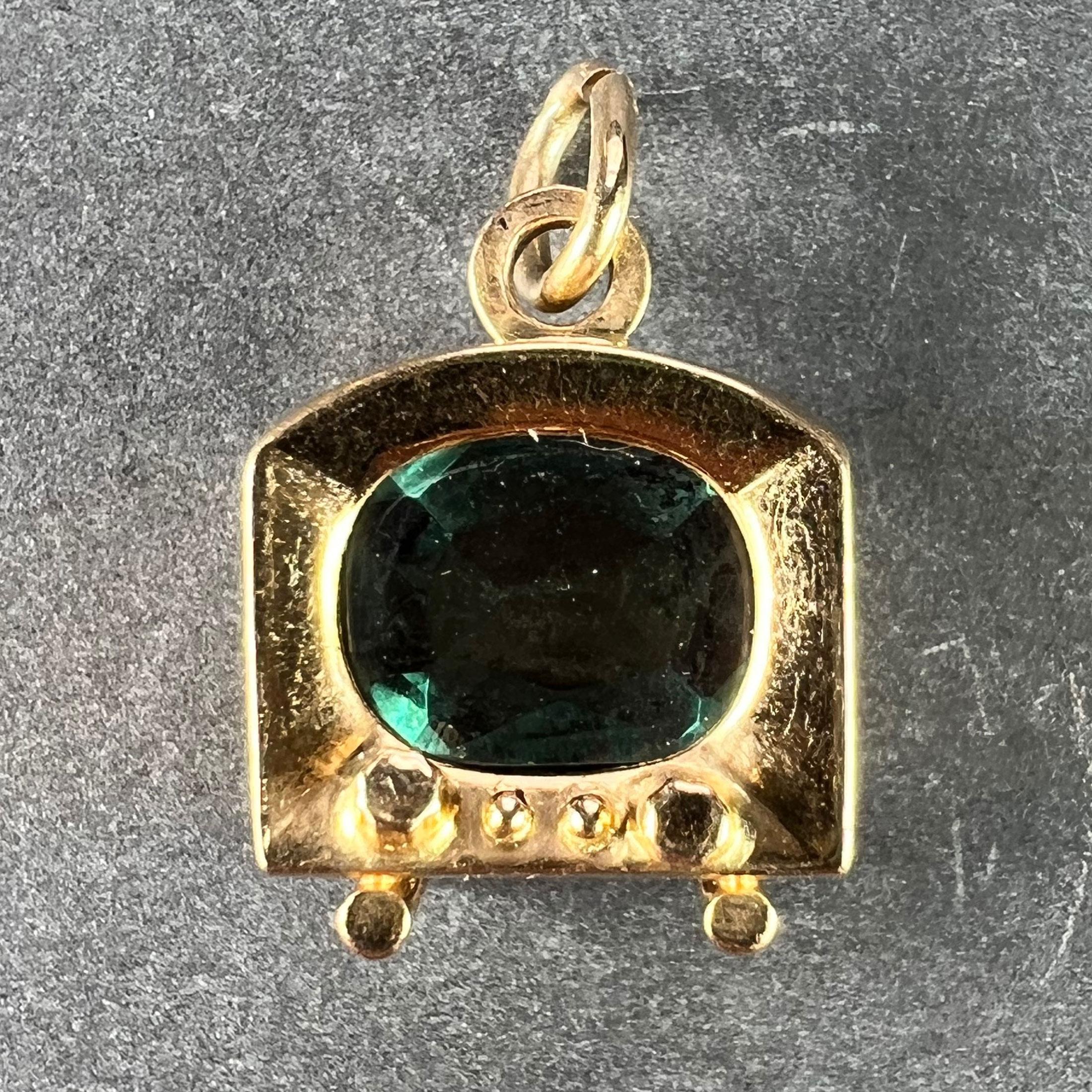 An Italian 18 karat (18K) yellow gold charm pendant designed as a TV or television with a green paste screen. Stamped 750 for 18 karat gold, 1AR for Italian manufacture and UnoAErre, along with their maker's mark.

Dimensions: 1.7 x 1.3 x 1 cm (not