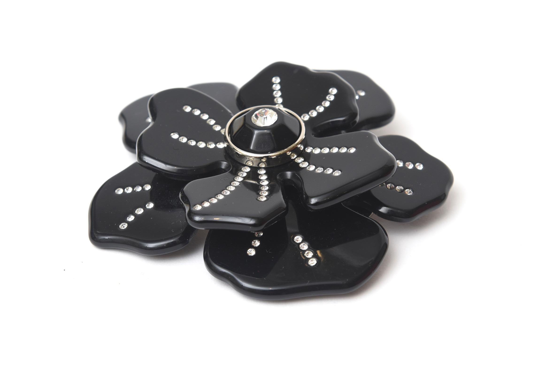 This lovely and dramatic Italian Valentino hard black resin rhinestone flower pin or brooch makes a beautiful addition to any ensemble given day or evening. It is from 2000. Very well made as any authentic Valentino piece is. It has its original