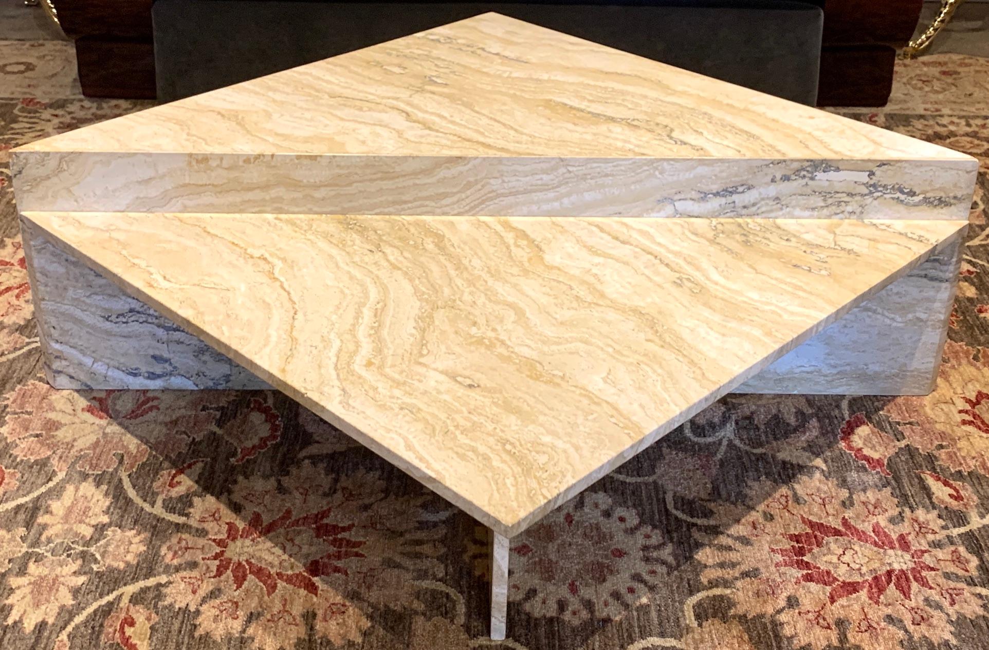 Italian variegated travertine two-tier coffee table, circa 1970s.
A tour de force in design and geometry. With two stunning specimen quality matched travertine sections, the taller piece measures 55