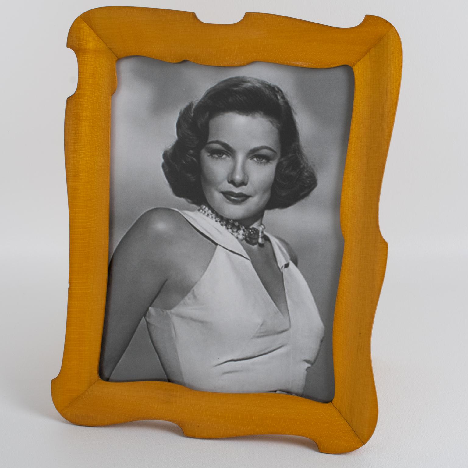 This elegant Italian Hollywood Regency picture frame boasts a lovely romantic beveled shape with varnished sycamore wood. There is a wood easel at the back. The designer monogram hallmark at the back is not identified.
Measurements:
Overall: 9.25 in