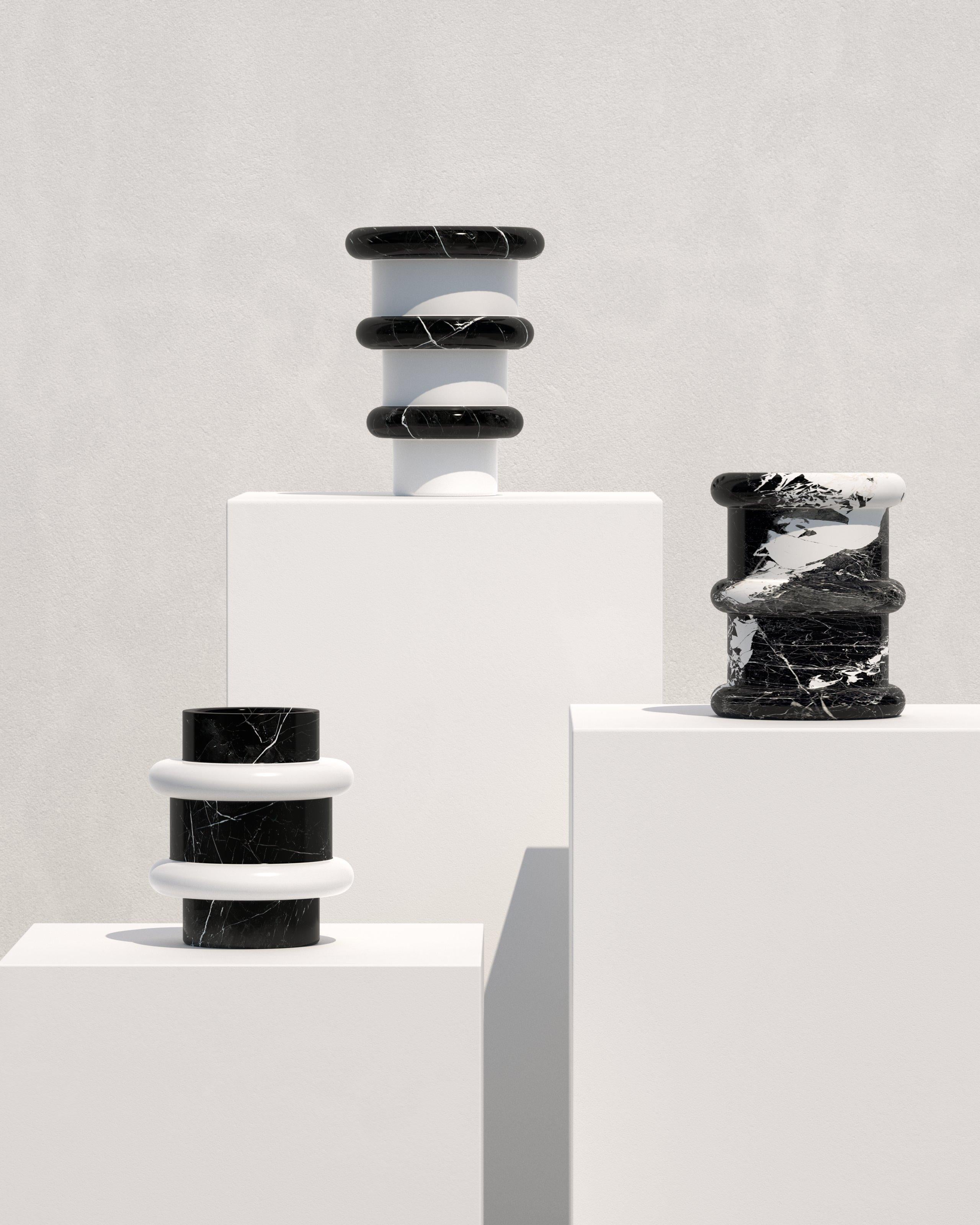 This minimalistic and playful vase in a bold black and white marble combination is a perfect item to add an authentic accent to any interior space. Made in Italy from natural marble, the Lumière vases offer playful shapes, clean silhouettes and high