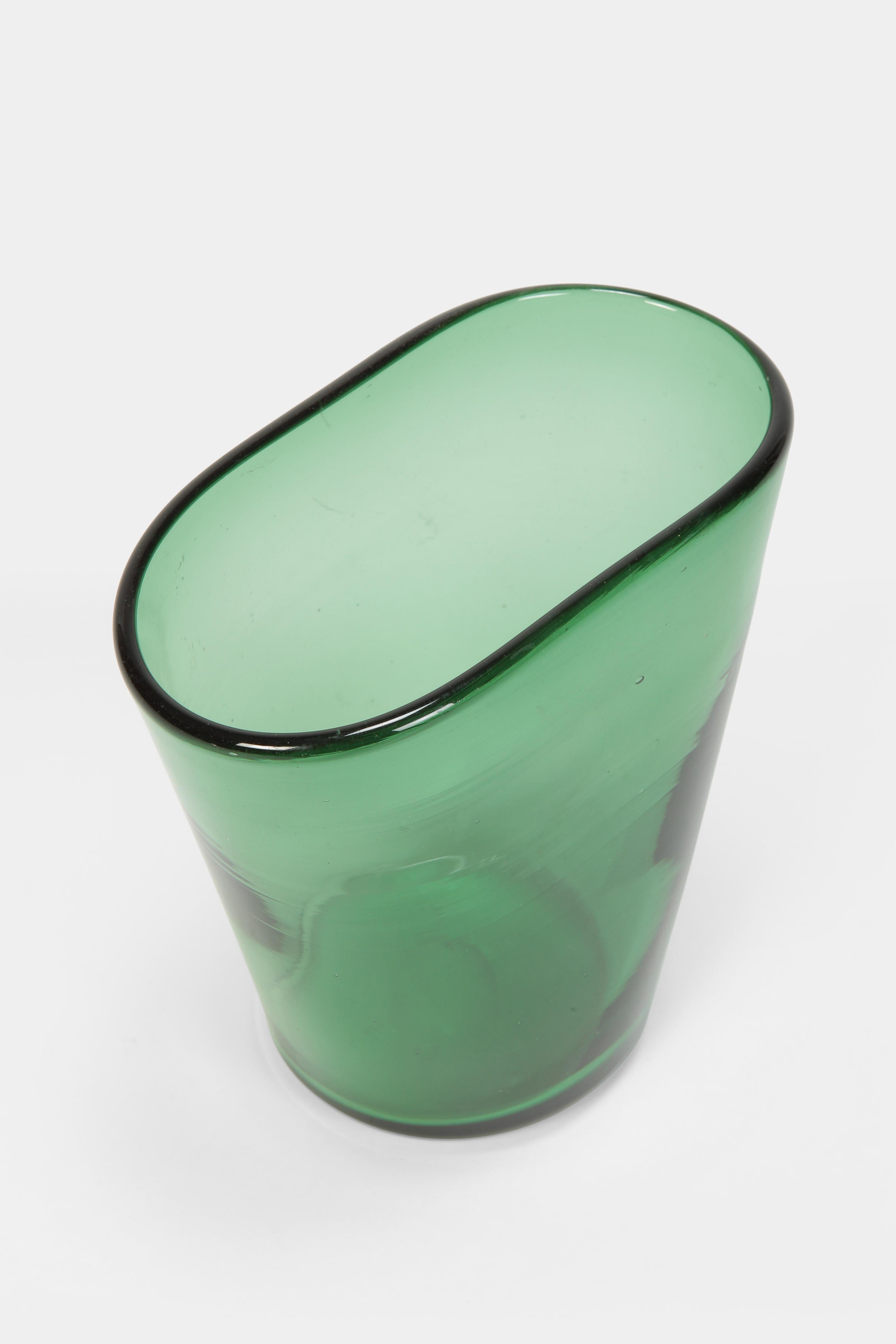 Vase manufactured by Vetro Verde di Empoli in the 1960s in Italy. Thick-walled vase out of luminous green glass with an oval opening.