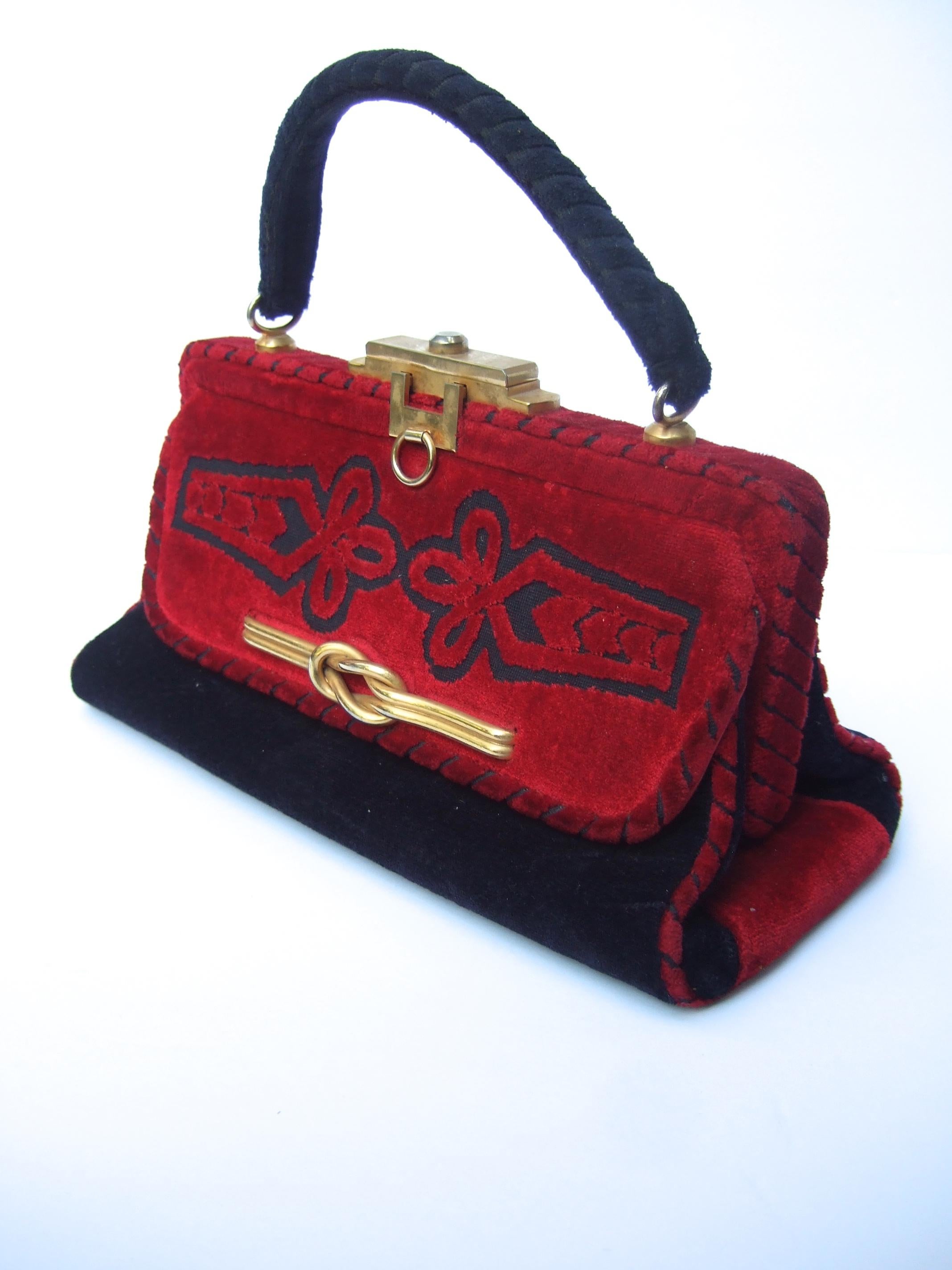 Italian velvet brocade handbag designed by Susan Gail c 1970s 
The stylish retro handbag is covered with plush velvet brocade 
Adorned with sleek gilt metal hardware

The clasp mechanism slides horizontally to release & open
The front exterior panel