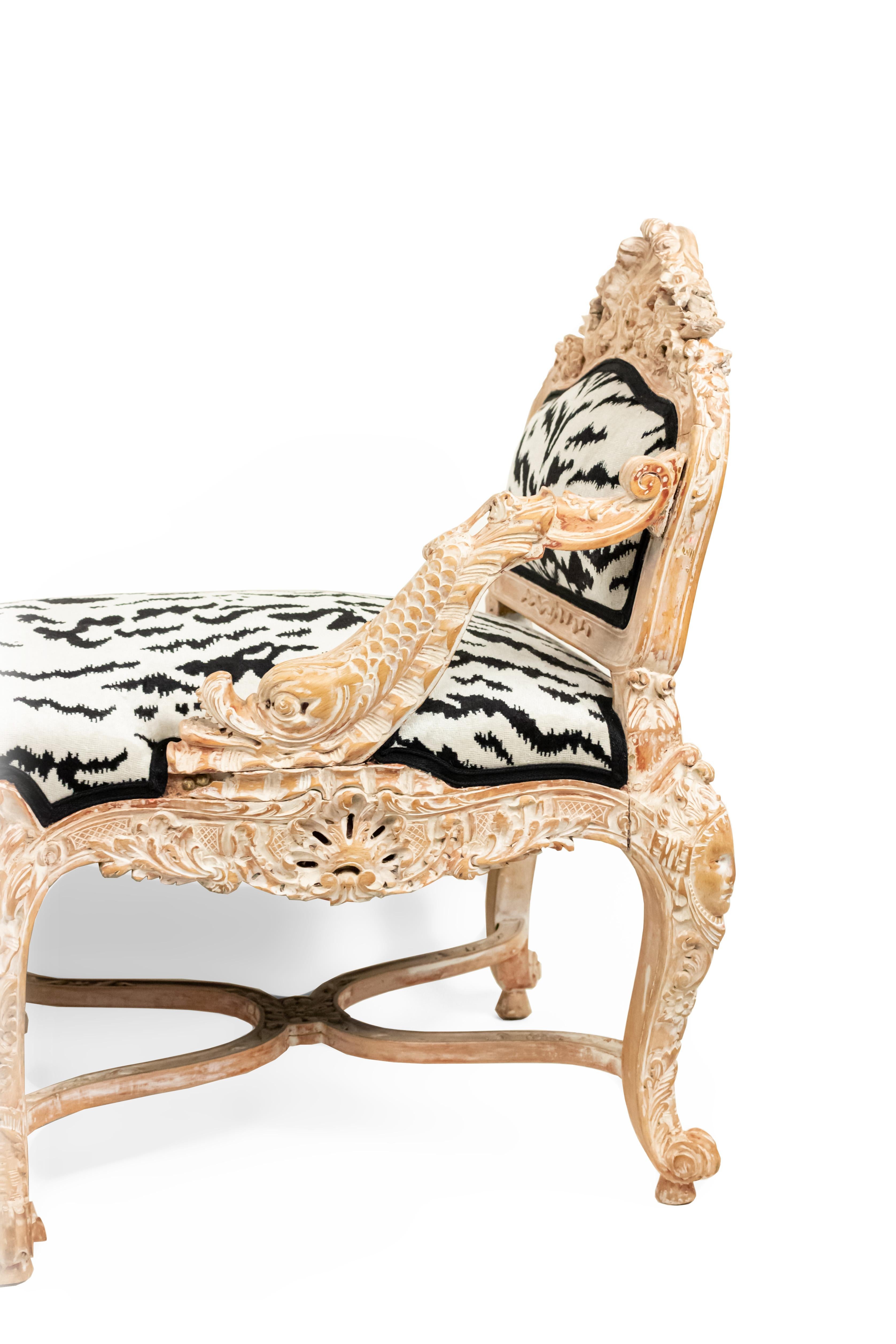 Italian Venetian style (19th Century) bleached tete-a-tete conversation seat with carved and upholstered black and white zebra print sides and dolphin arms.
