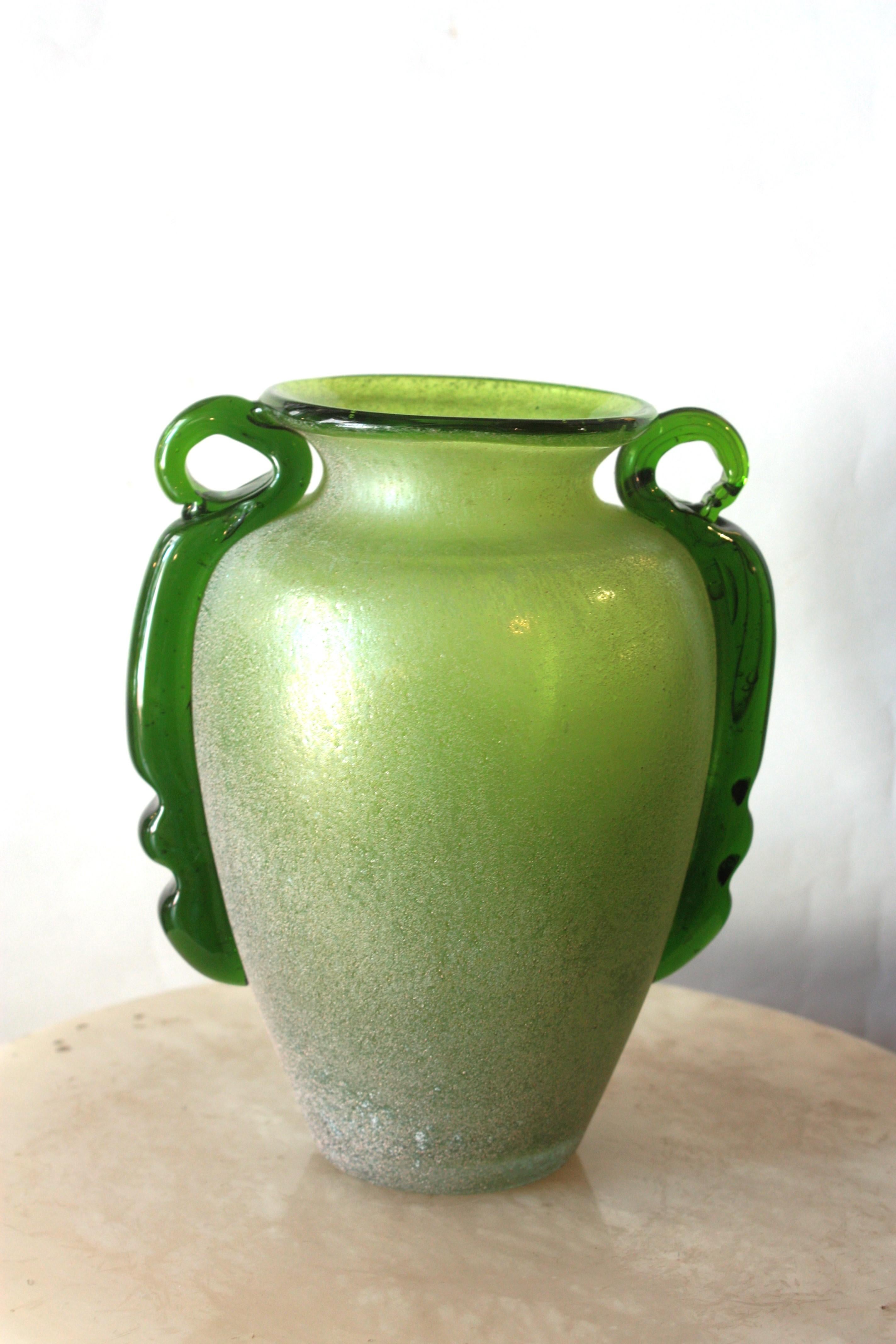 Carlo Moretti Green Scavo Corroso Art Glass Vase with Handles
Hand blown Murano glass scavo bianco corroso vase in acid green color with applied dark green handles. Attributed to Carlo Moretti, Italy, 1960s.
This eye-catching Murano glass bottle