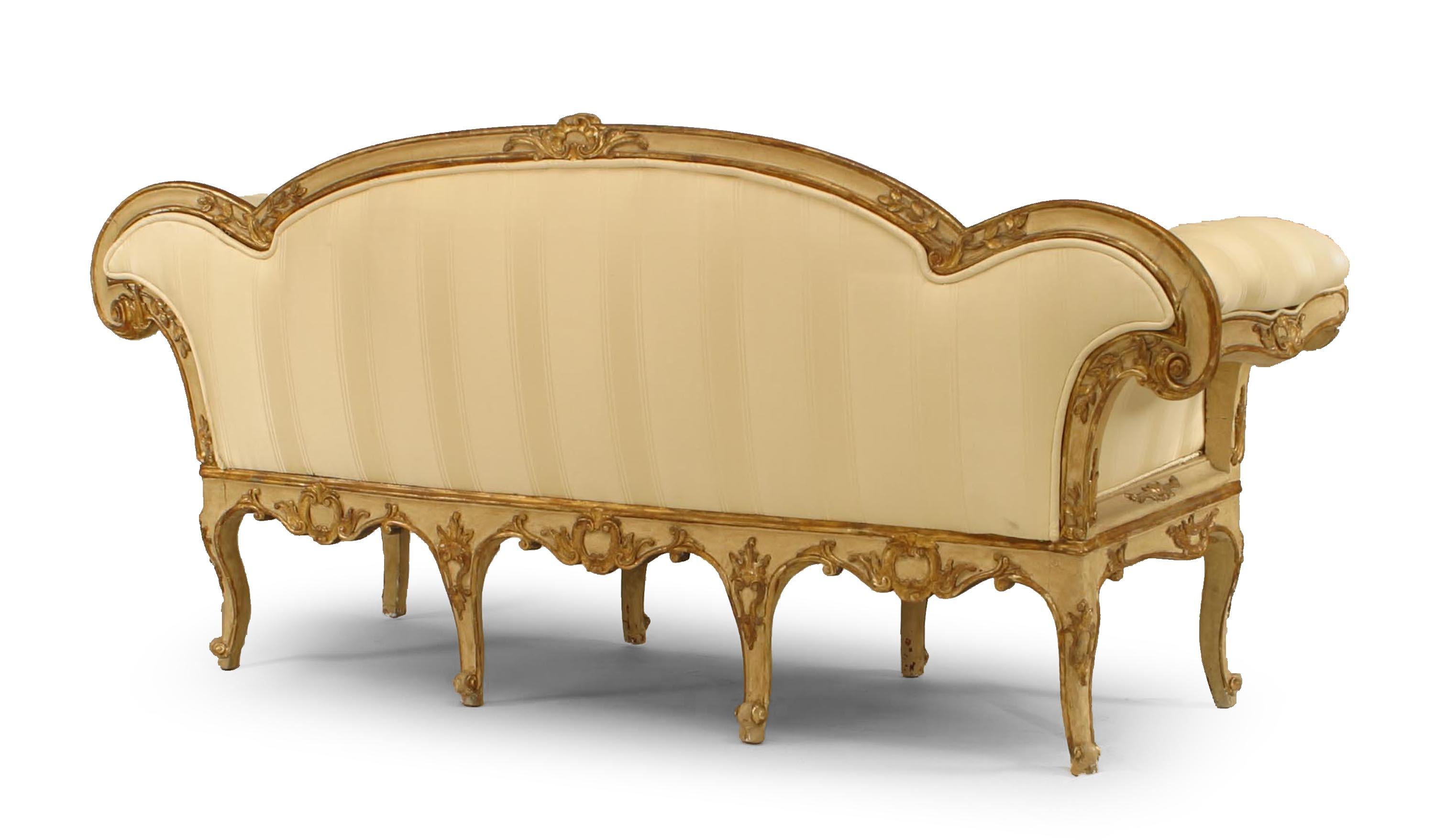 Italian Venetian (18th century) cream painted and gilt trimmed carved floral design settee with roll arms and carving on back (restorations to interior frame).