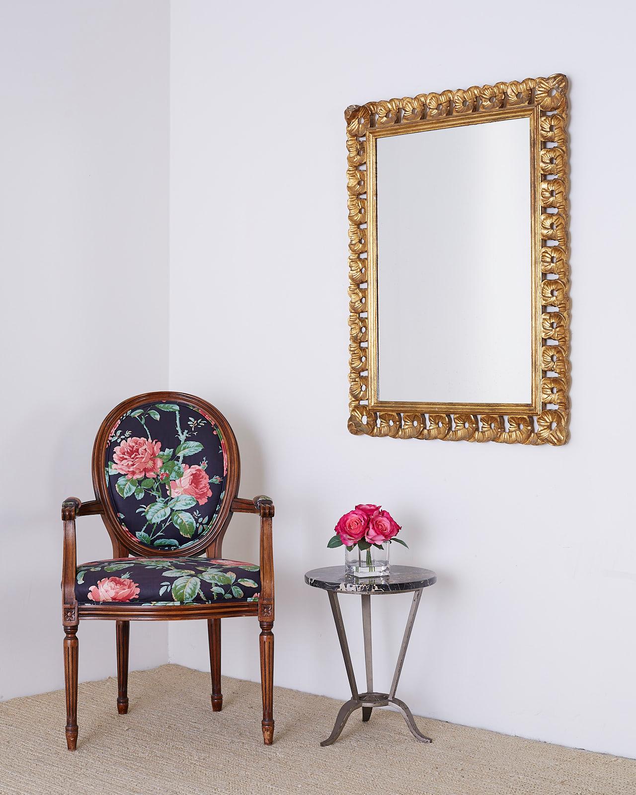 Remarkable Italian Venetian wall mirror featuring a hand carved, ribbon design of fluted and scalloped giltwood. The rectangular mirror can be mounted horizontal or vertical. Interesting design of repeating loops of ribbon with a vintage giltwood