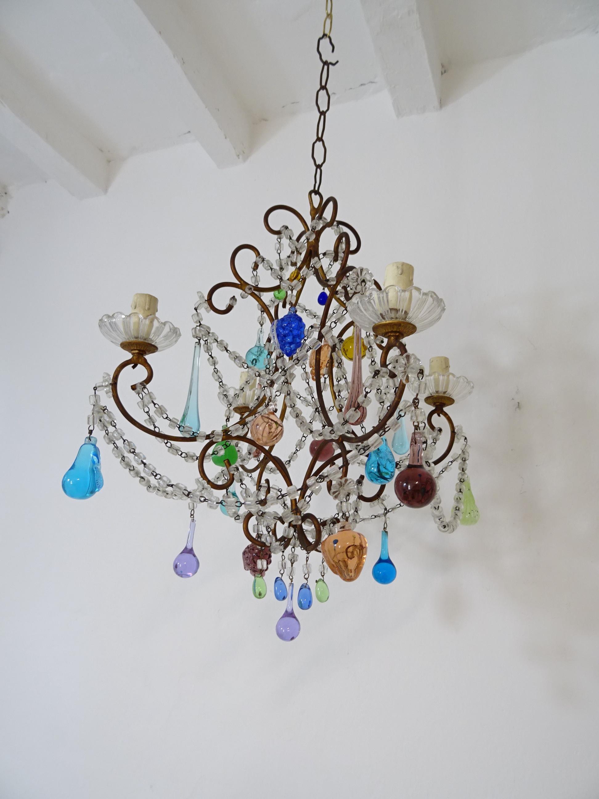 Housing 4 lights sitting in crystal bobèches. Swags of crystal macaroni and florets throughout with Murano fruit and drops in all shapes, colours and sizes. Adding 10 inches of original chain and canopy. Will be re-wired with certified UL US sockets