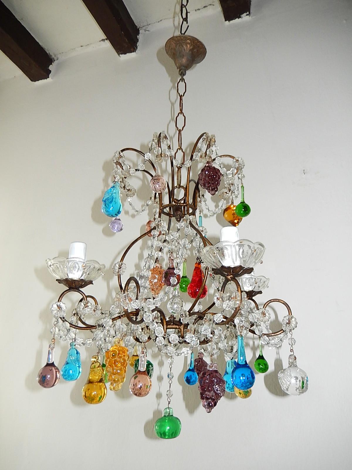 Housing 4 lights sitting in crystal bobèche. Swags of crystal and florets throughout with Murano fruit and drops. Adding 10 inches of original chain and canopy. Re-wired and ready to hang! Free UPS priority shipping from Italy.