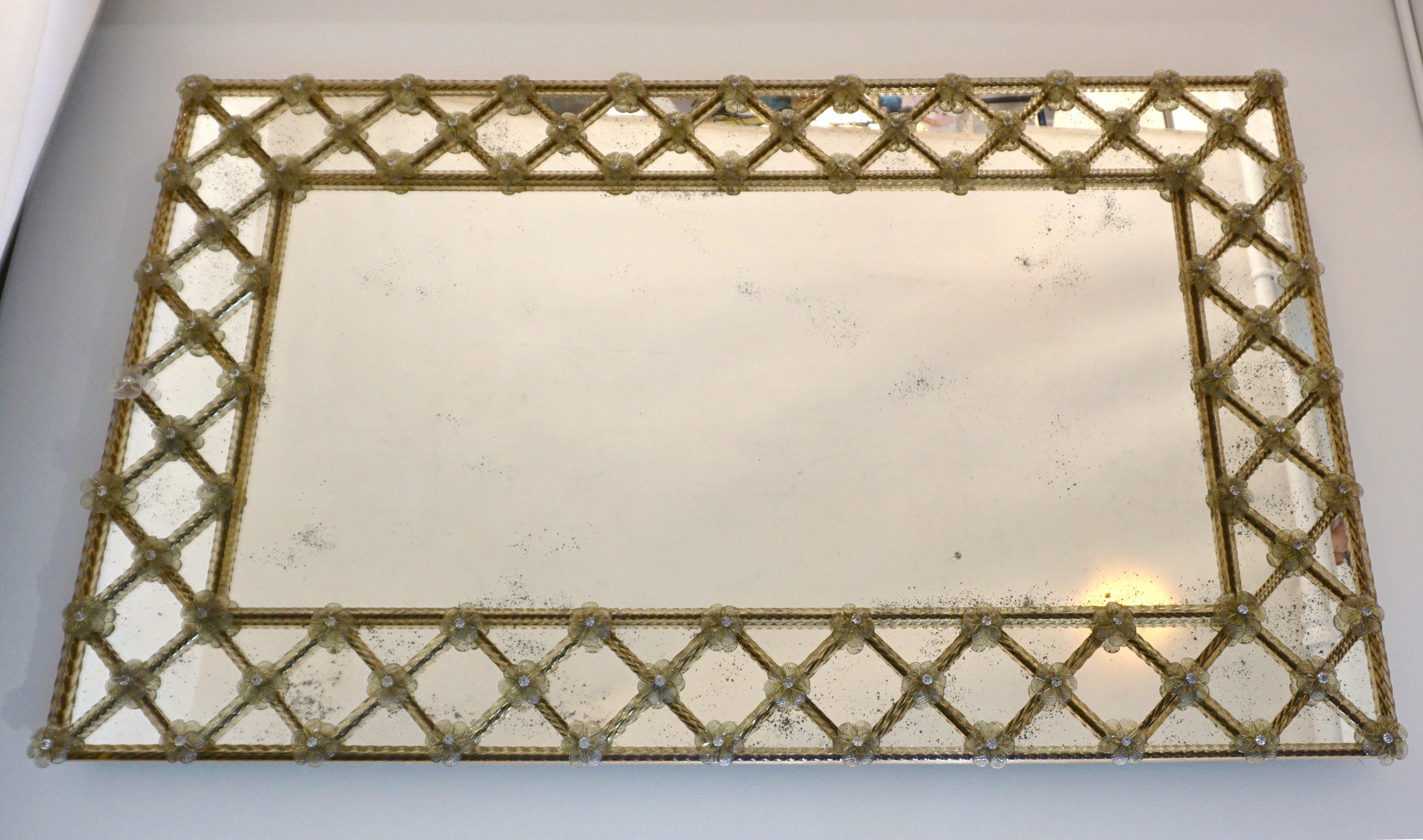 Venetian rectangular mirror, entirely handcrafted in Italy, a contemporary creation from an original design of the early 20th century, high quality of construction with hand gilt edged wooden back. The mirrored plate is enclosed in a mirror frame