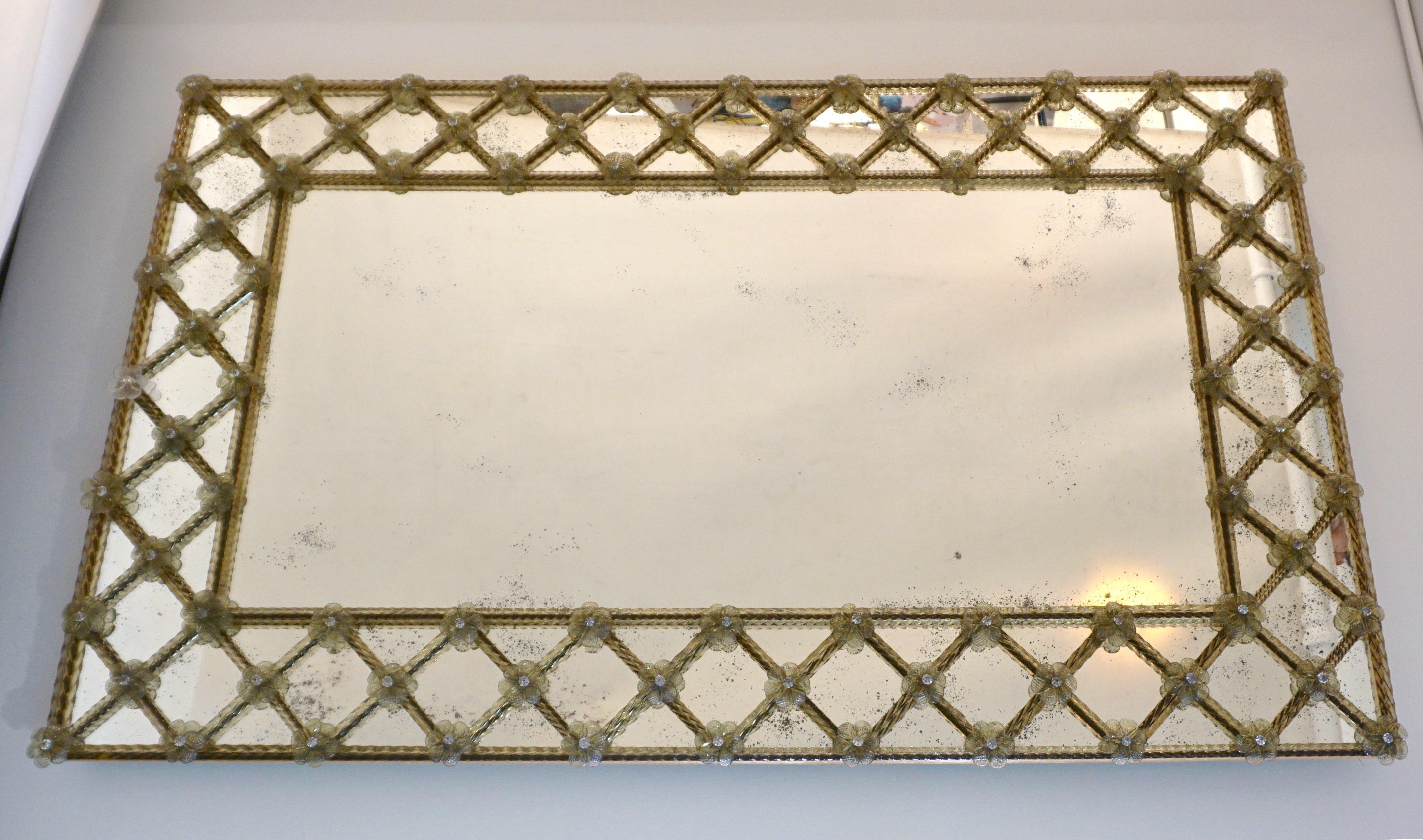Espejo rectangular veneciano, fabricado totalmente a mano en Italia, una creación contemporánea a partir de un diseño original de principios del siglo XX, de gran calidad de construcción con parte posterior de madera dorada a mano. La placa espejada
