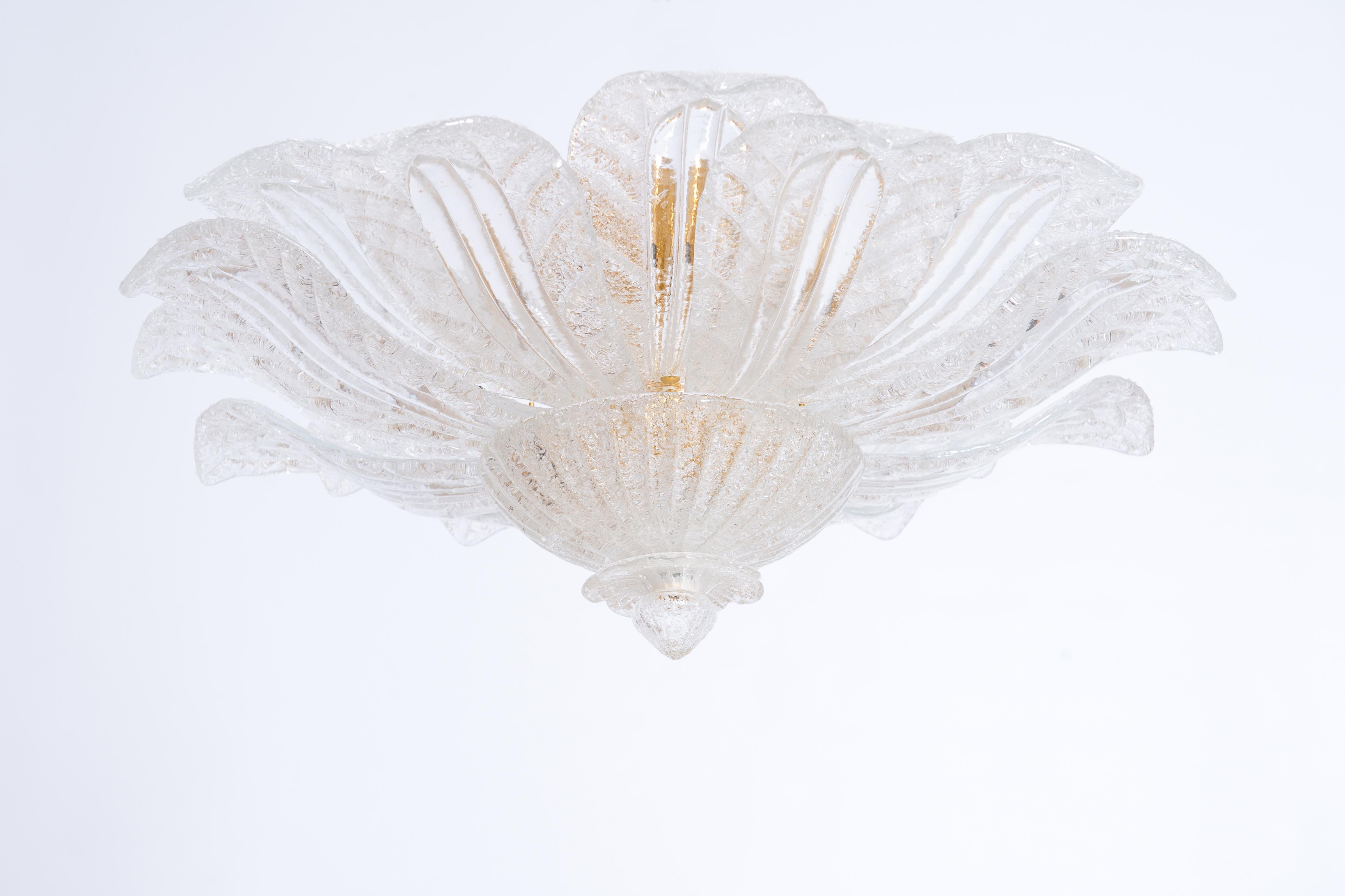 Elegant Leaves Motif Flush Mount clear color in Grit Murano Glass 1990s Italy.
This elegant flush mount it is a work of art stands out for the quality of its details and the beauty of its design. 
The gold inner frame is supporting the huge leaves