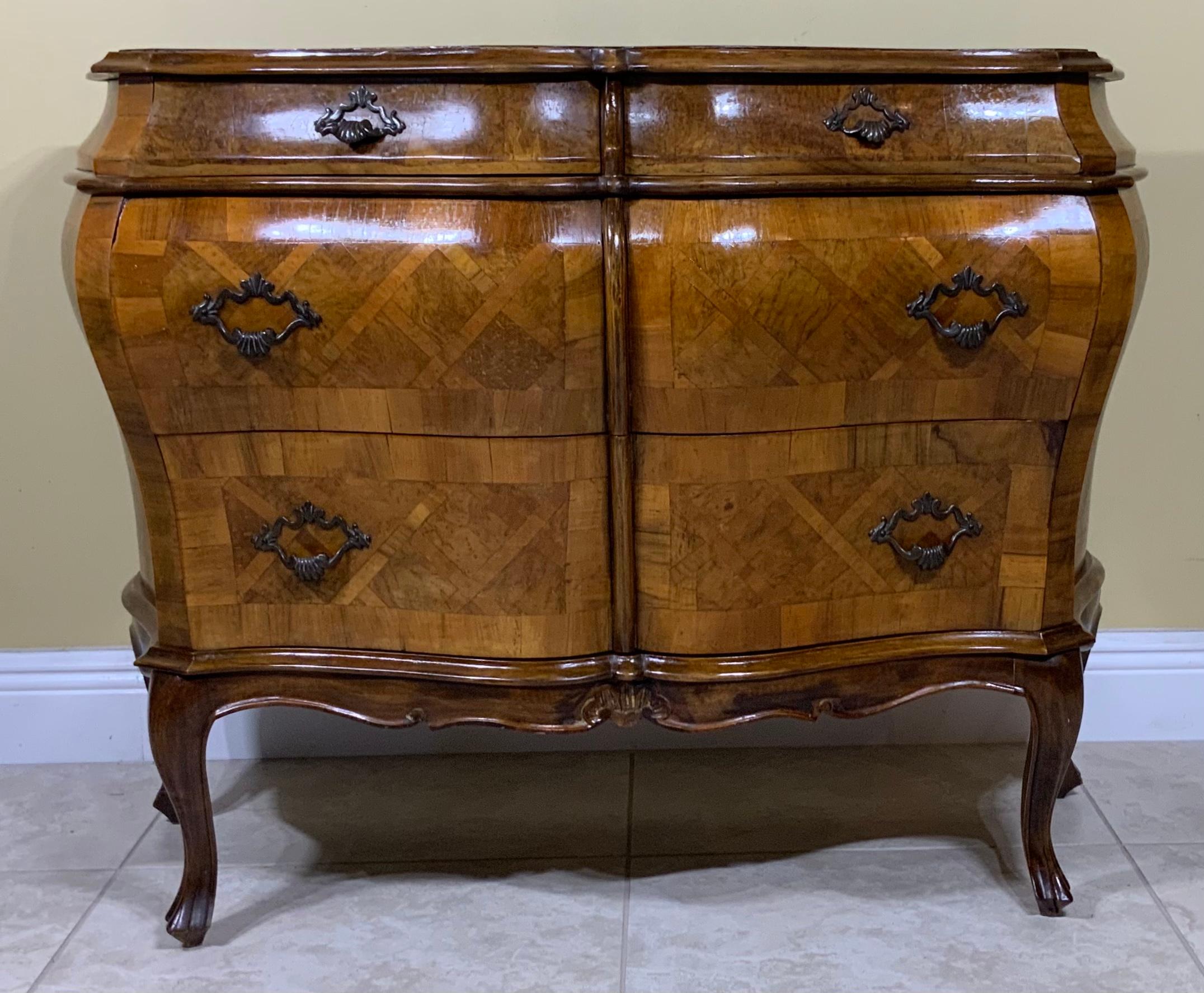 Beautiful 1960 Italian chest and drawers hand crafted and carved from walnut wood , Crisscross three sides and top with probably Olive wood geometric motif . The chest Has two large drawers and two small one at the top. brass hardware, and very nice