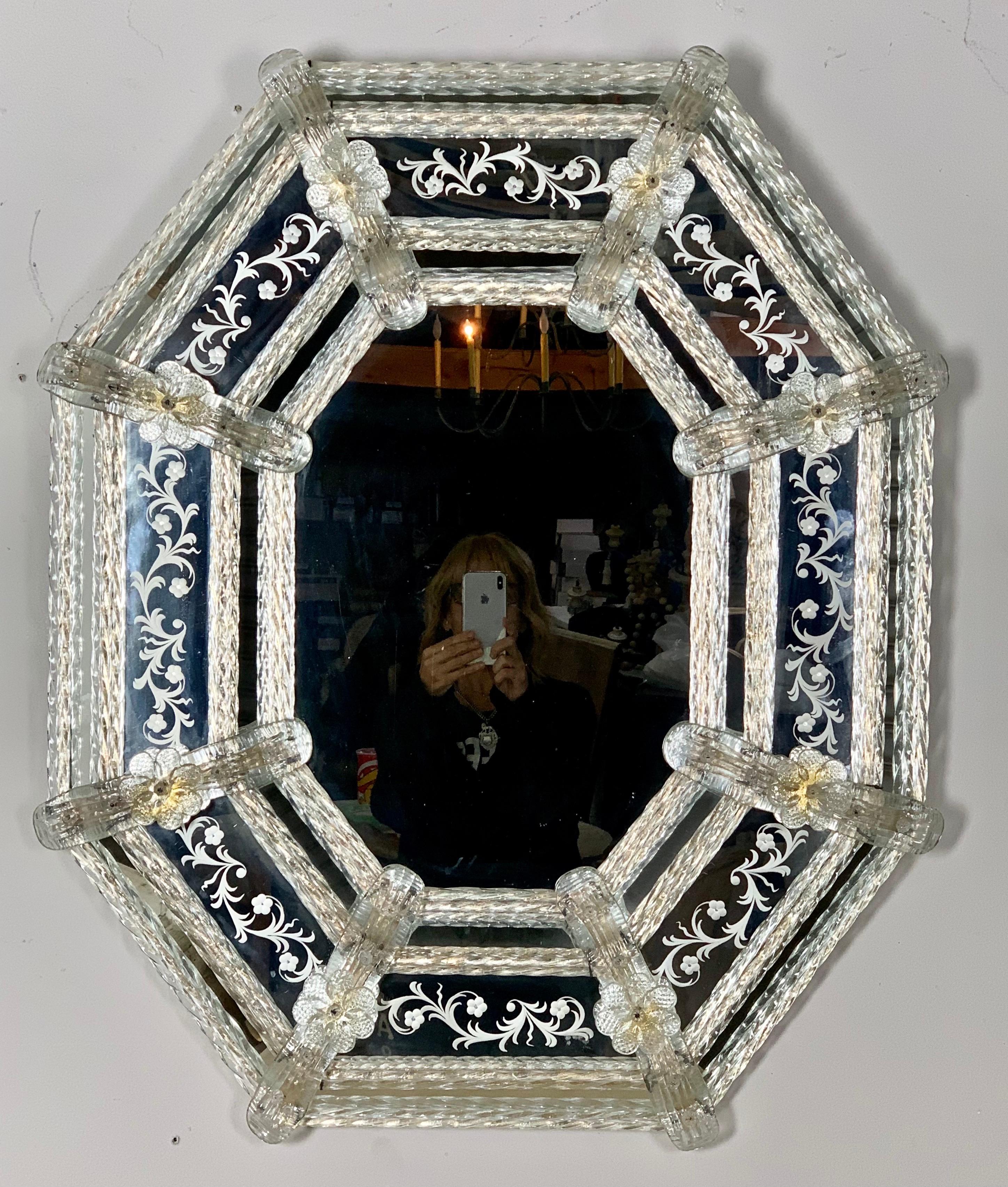 Octagonal shaped Venetian etched mirror made in Venetian glass and detailed with hand blown flowers, leaves, and so much more. There are gold flecks remaining on some of the flowers.