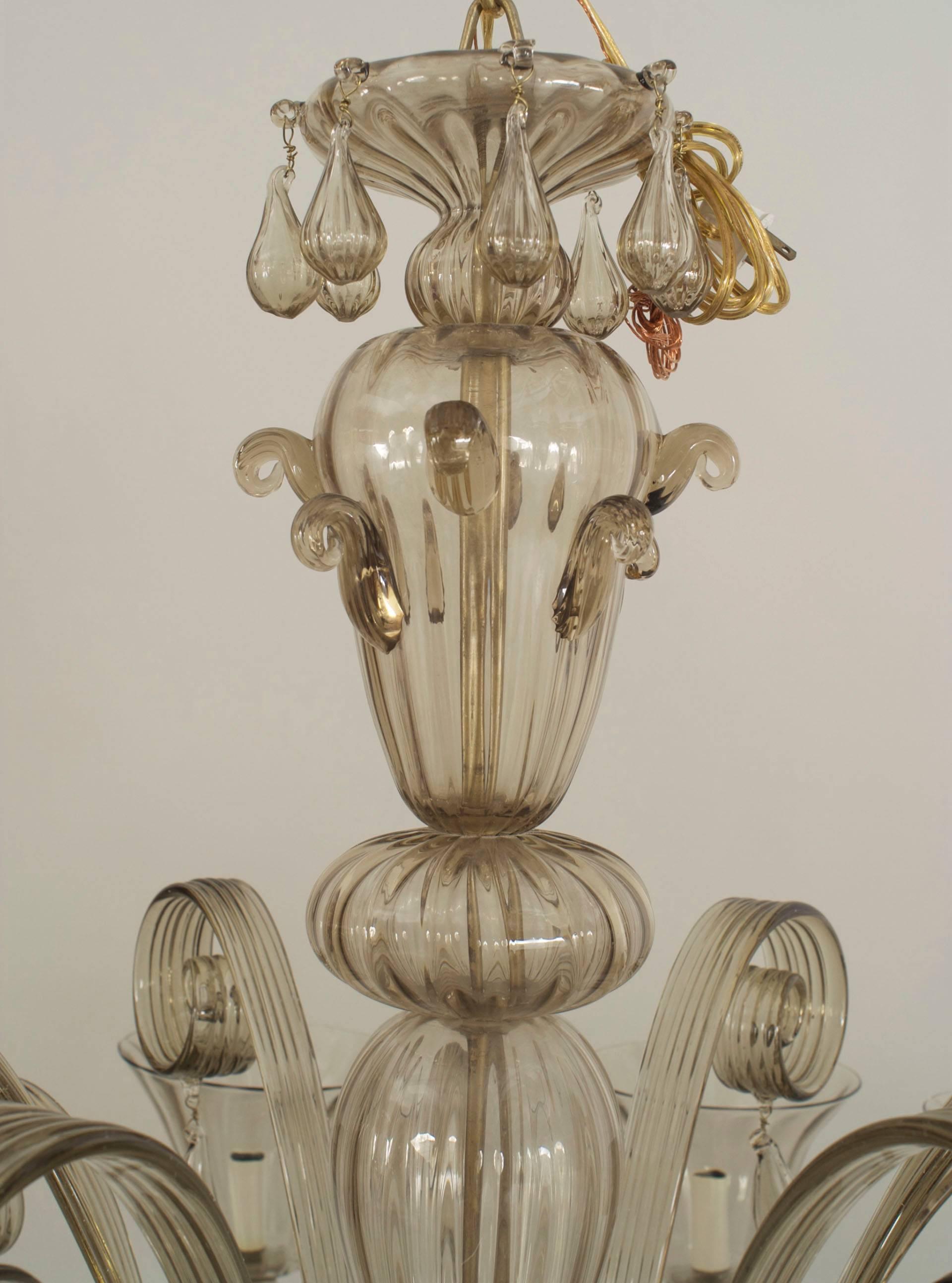 Italian Venetian Murano 12 fluted arm smoky glass chandelier with 12 up and 6 down scrolls with drops between the arms and emanating from a tiered base with a ball finial bottom.
