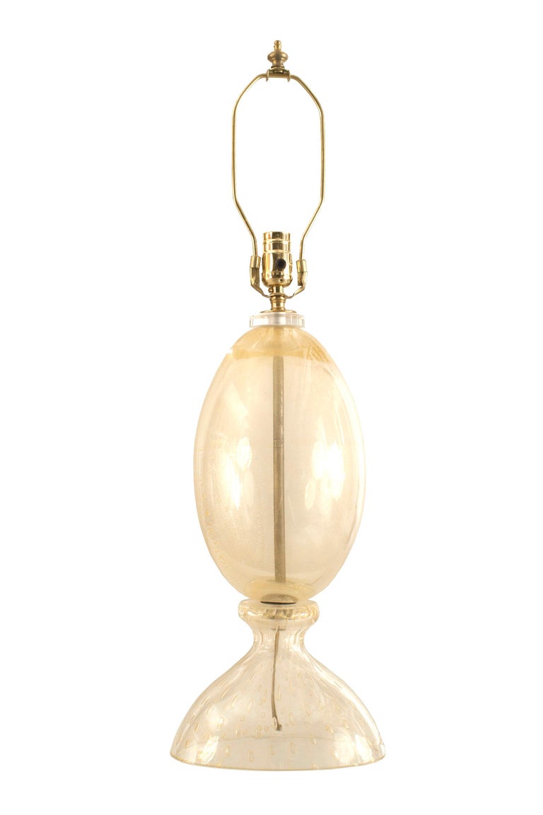 Italian Venetian Murano 1940 gold dusted glass lamp with a oviod form resting on an internal bubble glass base (by BAROVIER ET TOSO).

Barovier e Toso is a renowned Venetian company creating solutions of decorative lighting in Murano glass, all