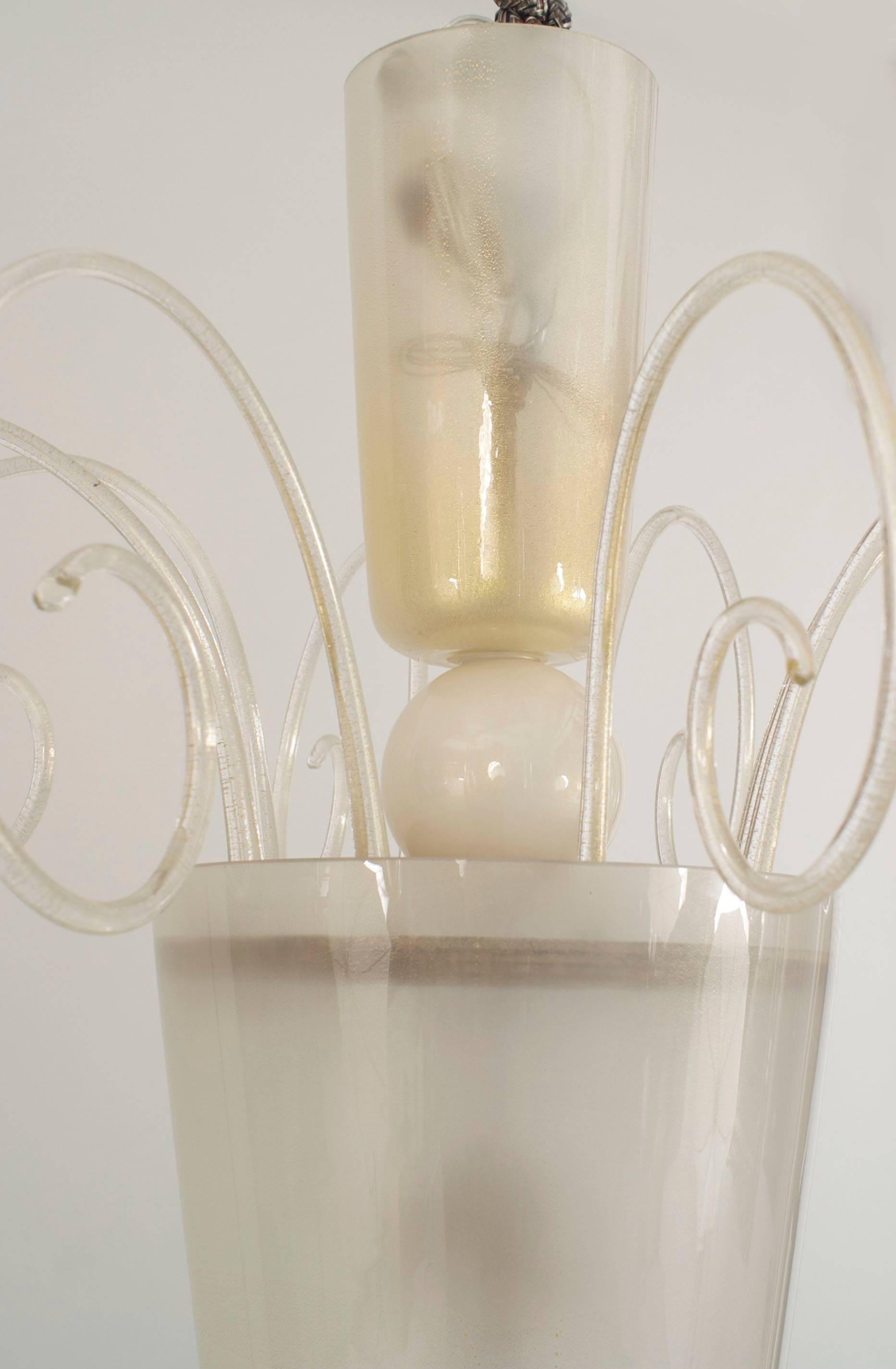 Italian Venetian Murano 1940s frosted glass lantern with a cone form and gold dusted glass scrolls emanating from the top with a ball bottom above a brass finial. (SEGUSO).
