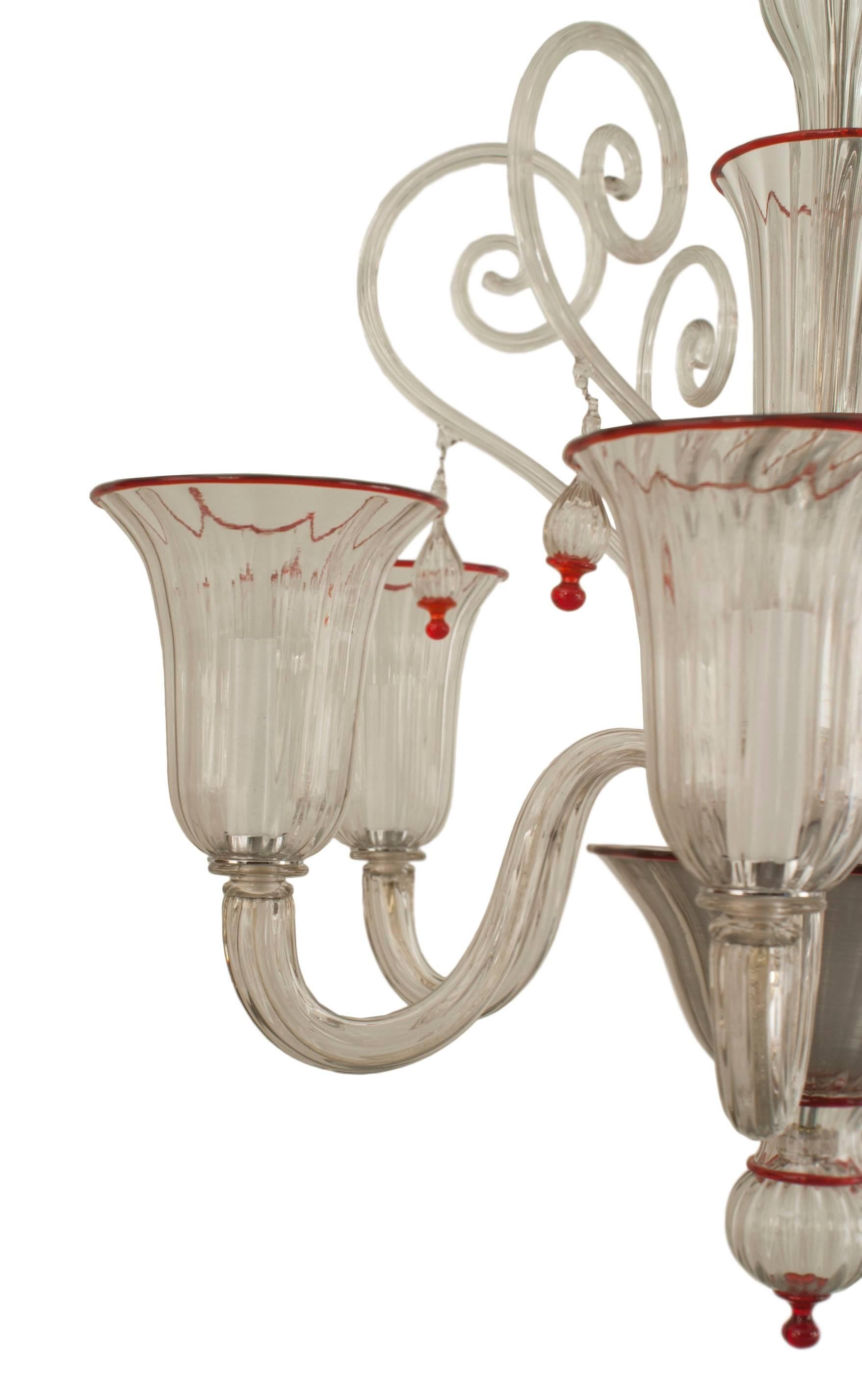 Italian Venetian-Style (1940s) Murano clear glass and red trimmed chandelier with 6 fluted scroll arms with large cups with 6 large glass scrolls emanating from a 3-tier center shaft with a final bottom
