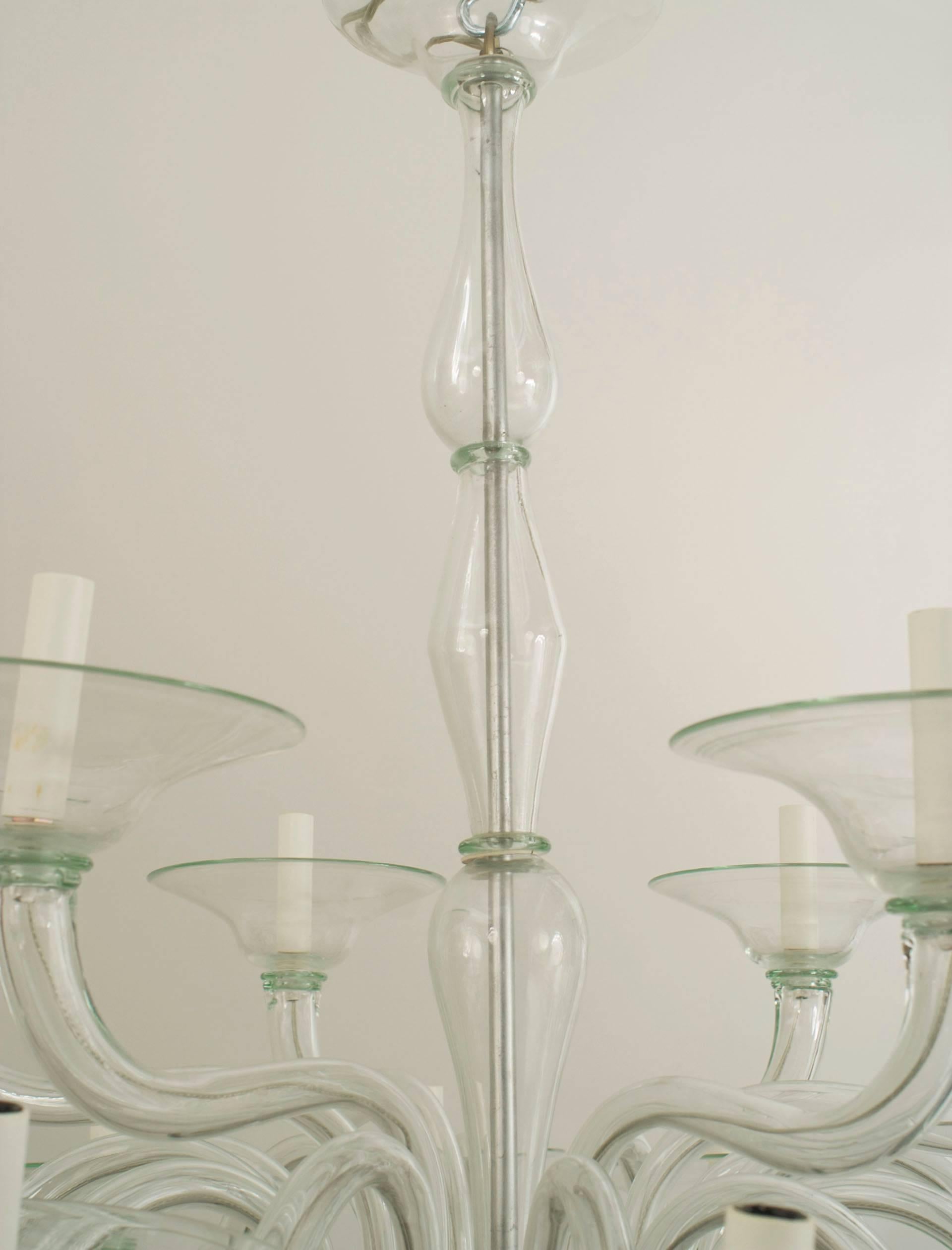 Italian Venetian (1940's) style Murano light green glass chandelier with 2 tiers of 6 and 12 scroll arms emanating from a tiered centerpost with disc form bobeches cups and a finial bottom.
