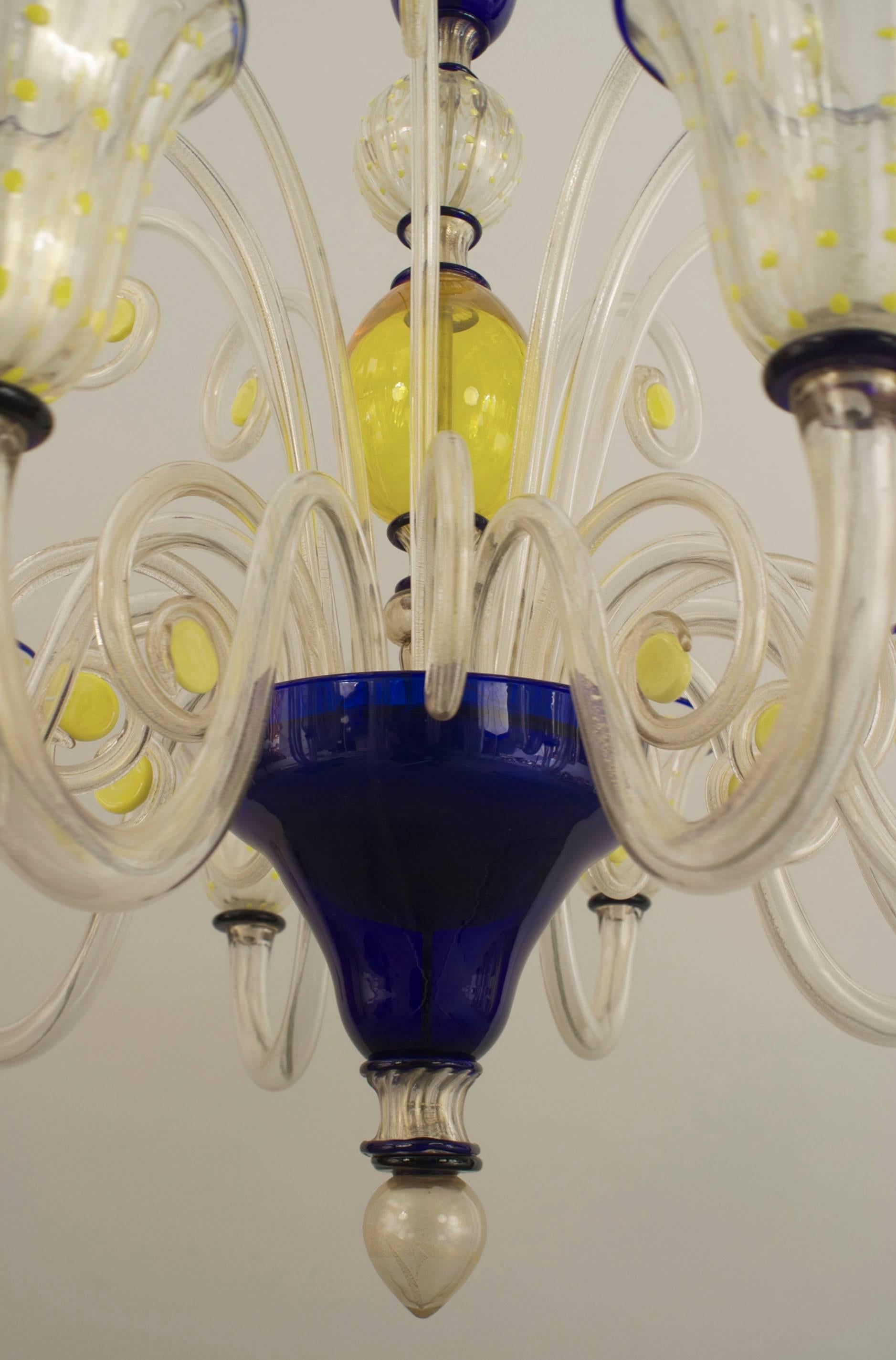 Italian Venetian Murano (1940s) yellow & blue trimmed glass chandelier with 12 scroll arms supporting yellow dot decorated shades & 24 glass scrolls emanating from a center shaft with a final bottom. (PAOLO VENINI)
