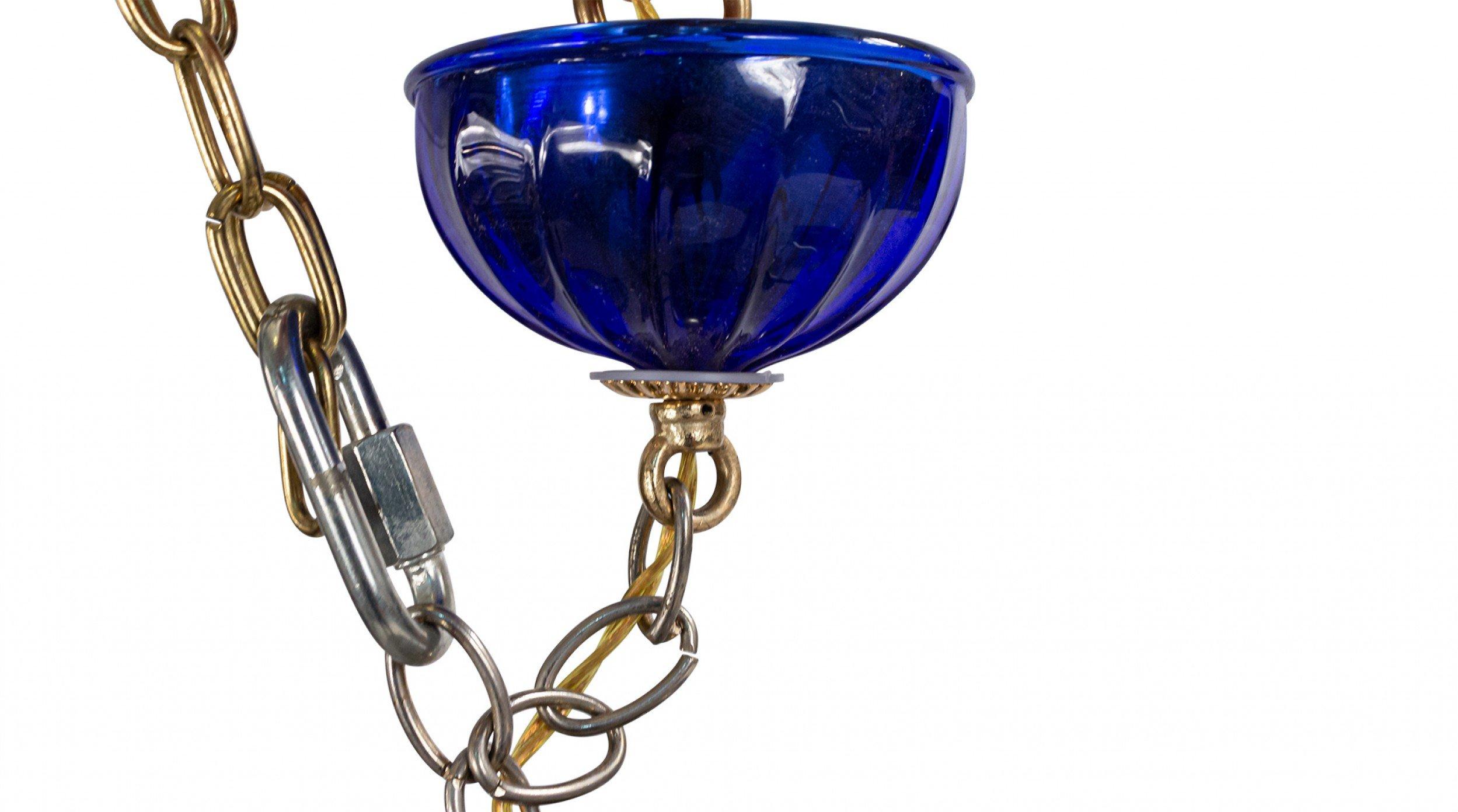 Italian Venetian Murano (Modern) blue glass chandeliers with 5 fluted scroll design arms and circular shades emanating from a segmented stem with a ball finial bottom (similar 6 arm: )VTP1620).
      