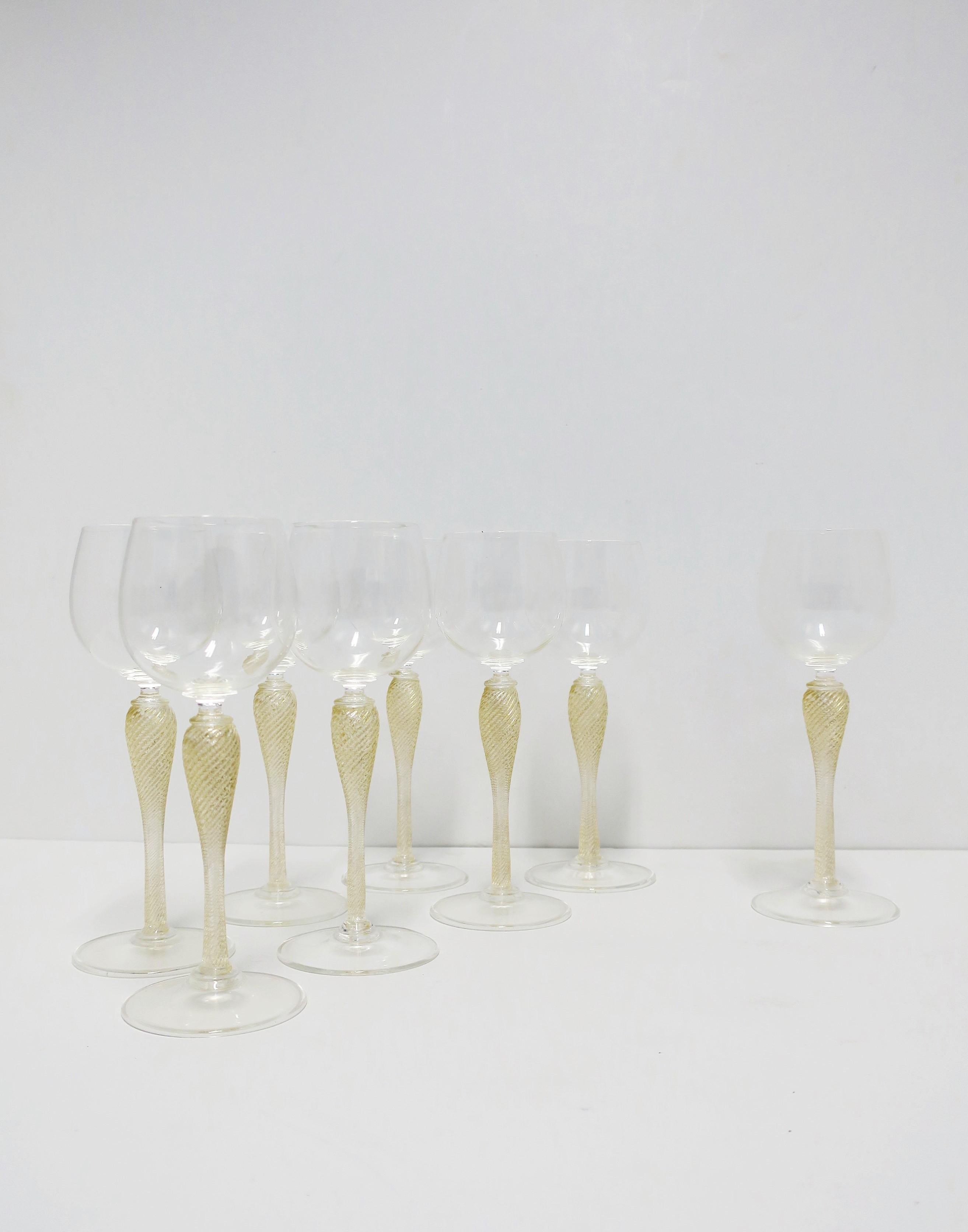 A beautiful set of eight (8) Italian Venetian Murano gold and transparent art glass wine, Champagne or cocktail glasses by Cenedese, circa late-20th century, Italy. Many types of drinks/cocktails/beverages can be enjoyed with these glasses. A