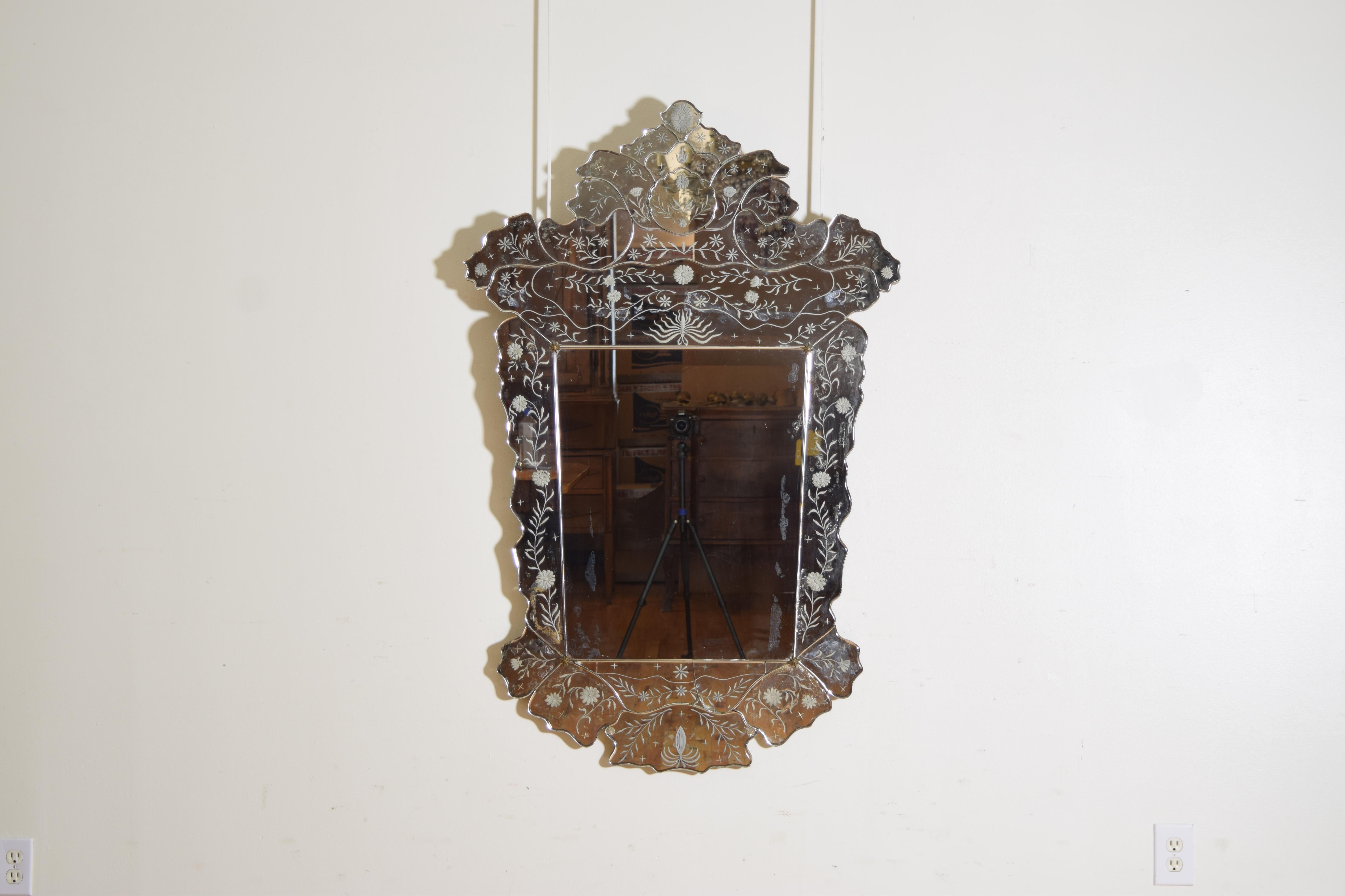 Having original glass, brass star pins holding center glass plate and glass rosette pins holding the shaped cuts on the boarder of the frame.  The etchings are of restrained florals which is unusual as typically the subjects are figural etched into