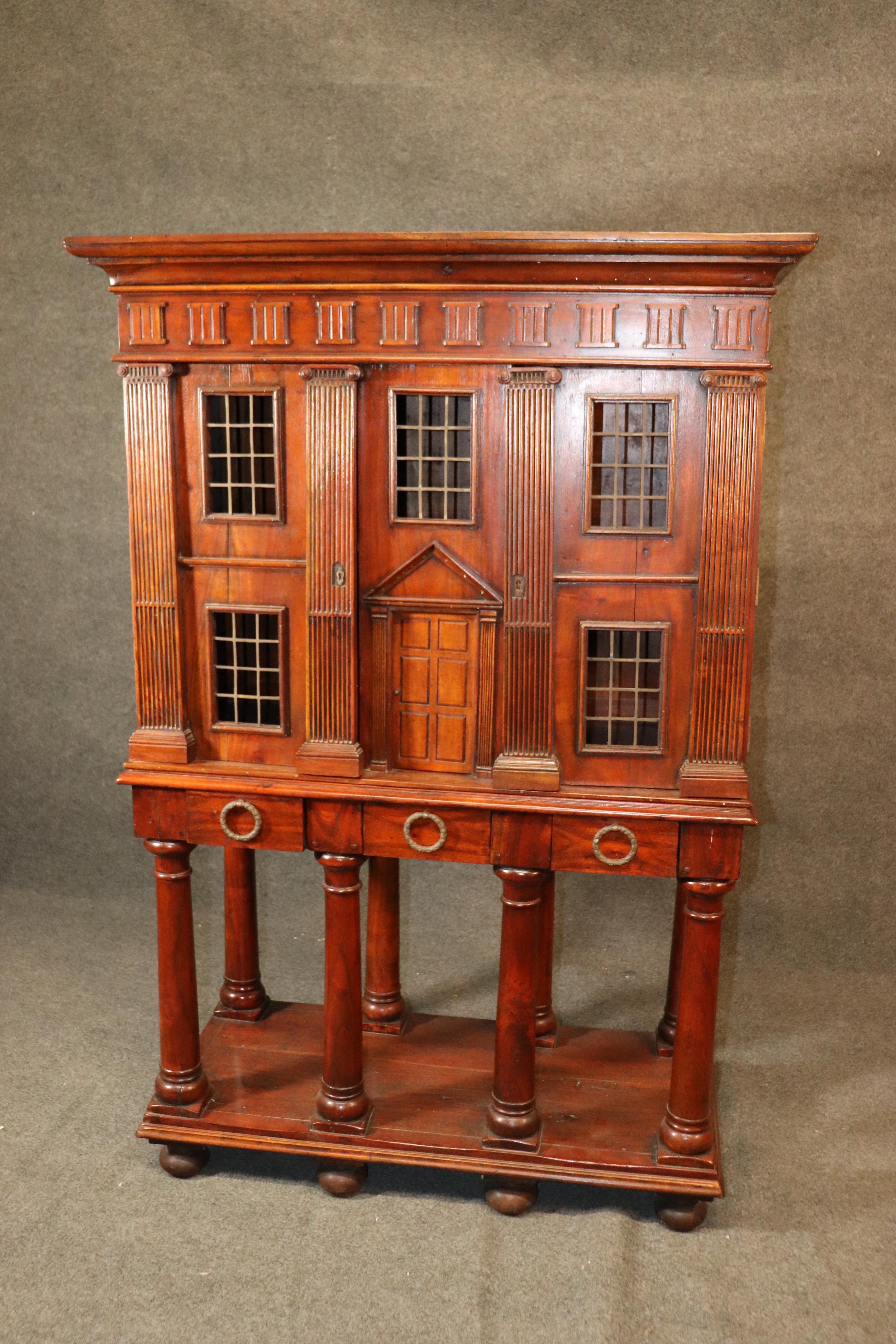 This cabinet was designed to look like an Italian or Spanish Villa or mansion. The cabinet is made of solid mahogany and is in good vintage condition. The cabinet appears to be 100 years old but truthfully it can be older or newer than that. Its