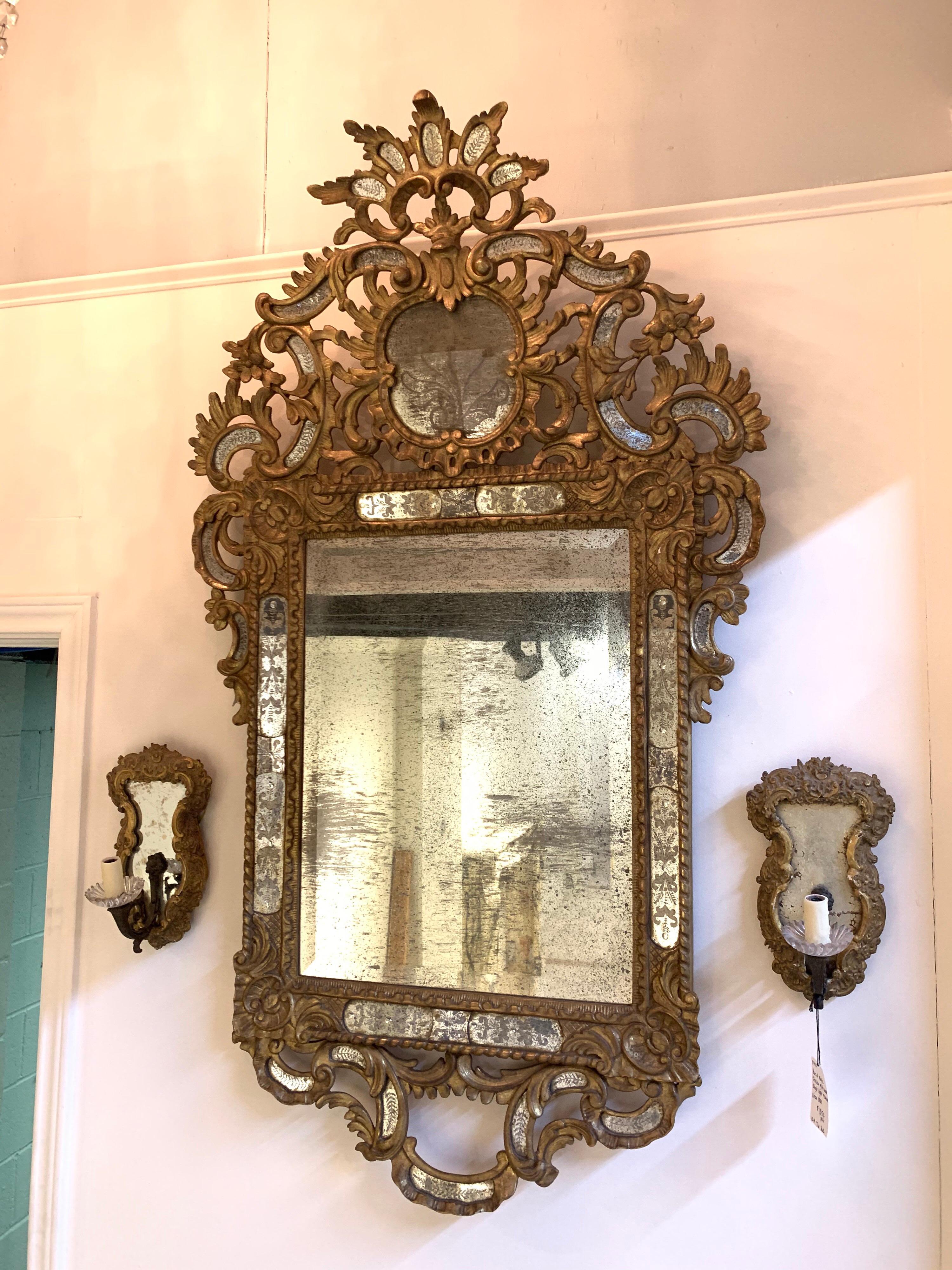 Fine quality Italian Venetian style carved and giltwood mirror with etched glass. Lovely intricate carvings with inlaid etched glass. Creates a beautiful effect. So elegant!