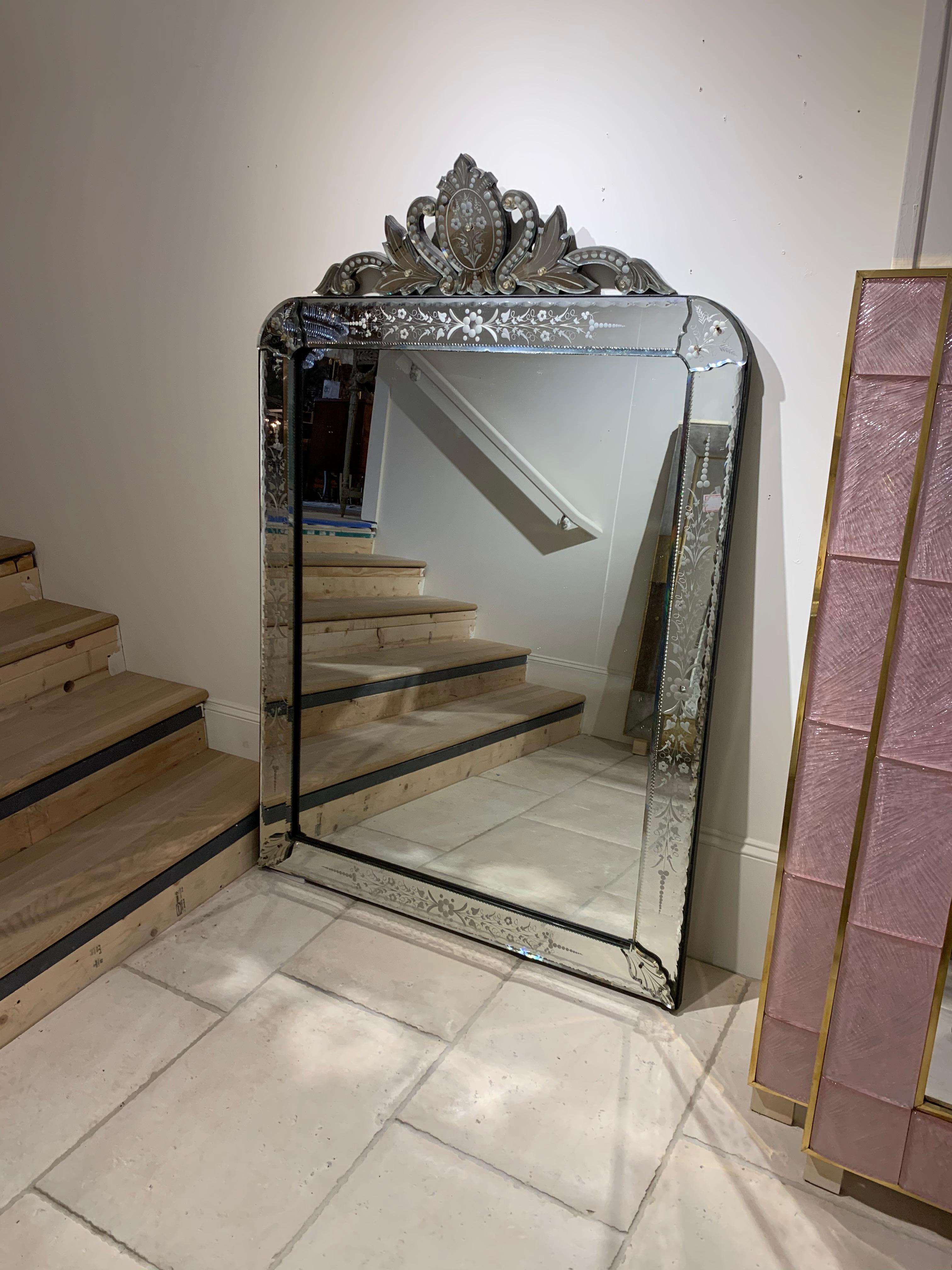 Exquisite Italian Venetian style etched glass mirror. The mirror has a beautiful crown and the top and very Fine etched images. Would be gorgeous over a mantel (fireplace)!
 