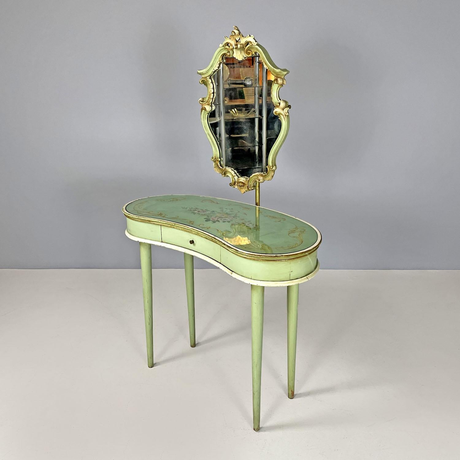 Italian Venetian style green and golden wood console with mirror, 1950s 
Wooden console with mirror. The structure is in light green lacquered wood, the glass top is oval and elongated, with the sides curving inwards. Under the glass the top