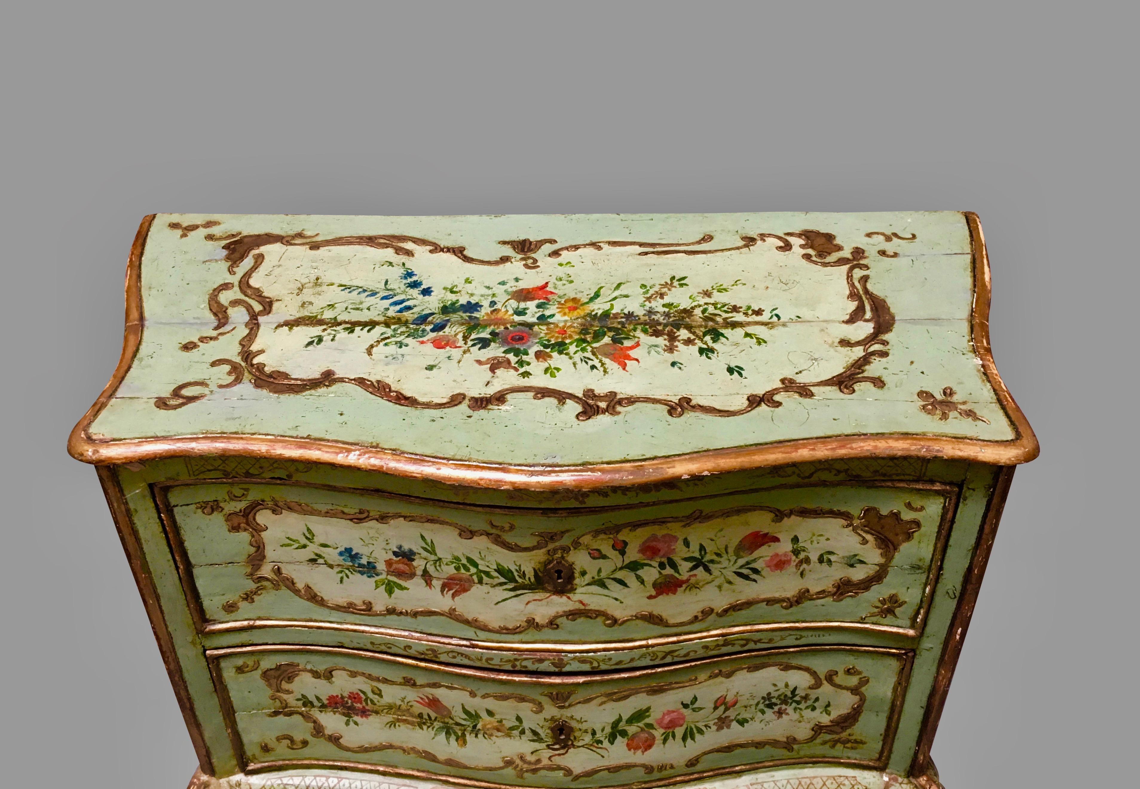 A very pretty Italian Rococo style serpentine 2-drawer commode, the green ground painted overall with foliate and gilt decoration within cartouches, resting on cabriole legs ending in stylized ball and claw feet.
