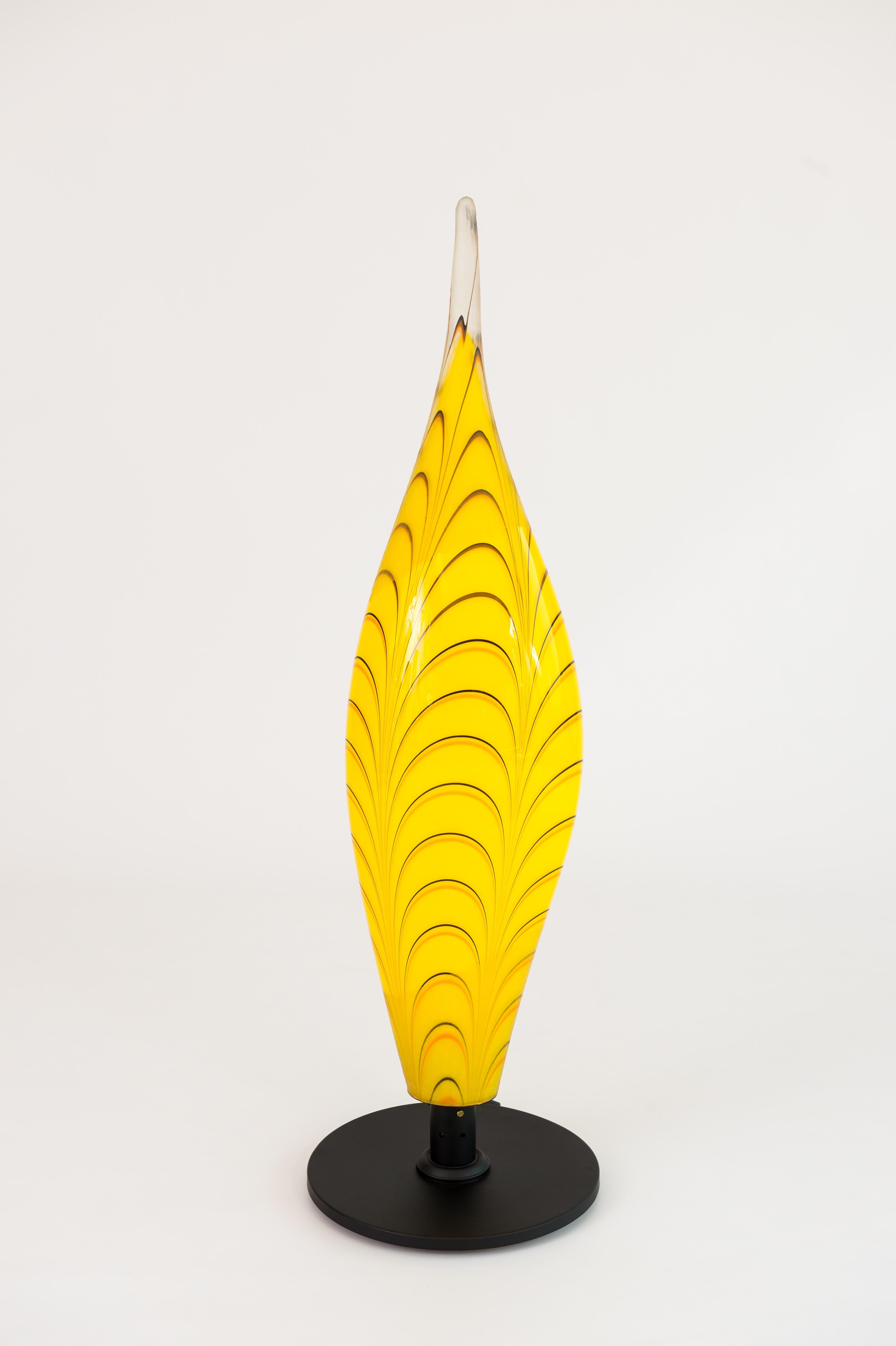 Unique modern, Italian Table Lamp in Blown Murano Glass Yellow and Black stripes, 1990s.
This magnificent table lamp, is entirely handcrafted, in blown Murano glass, the main body is a huge element having the shape of a huge yellow flame, decorated