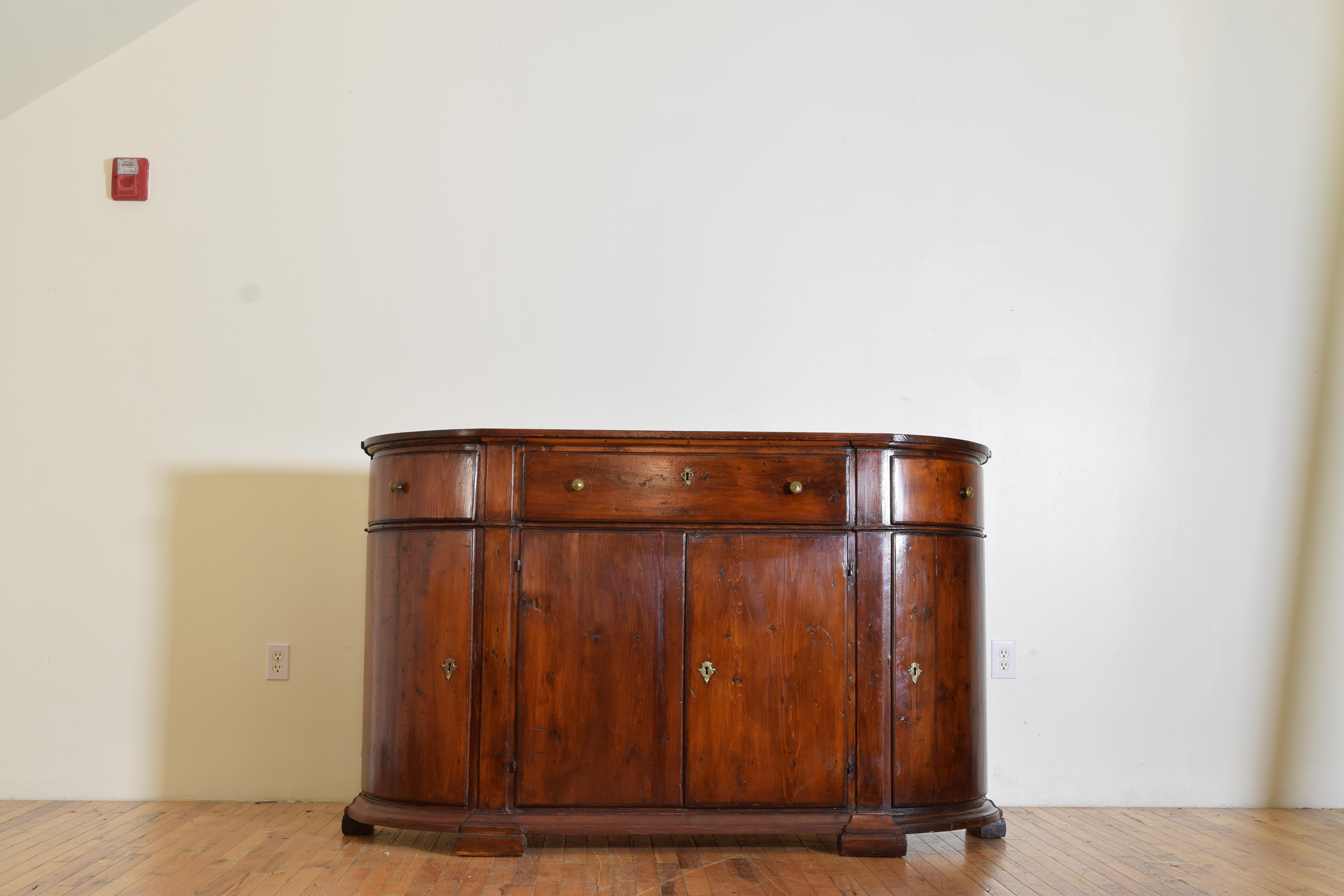 Coming from the mountains in the Northern part of the Veneto region of Italy this credenza features a rectangular top with convex curving sides, with one large centered drawer flanked by two smaller curved, drawers, the lower part of the case with
