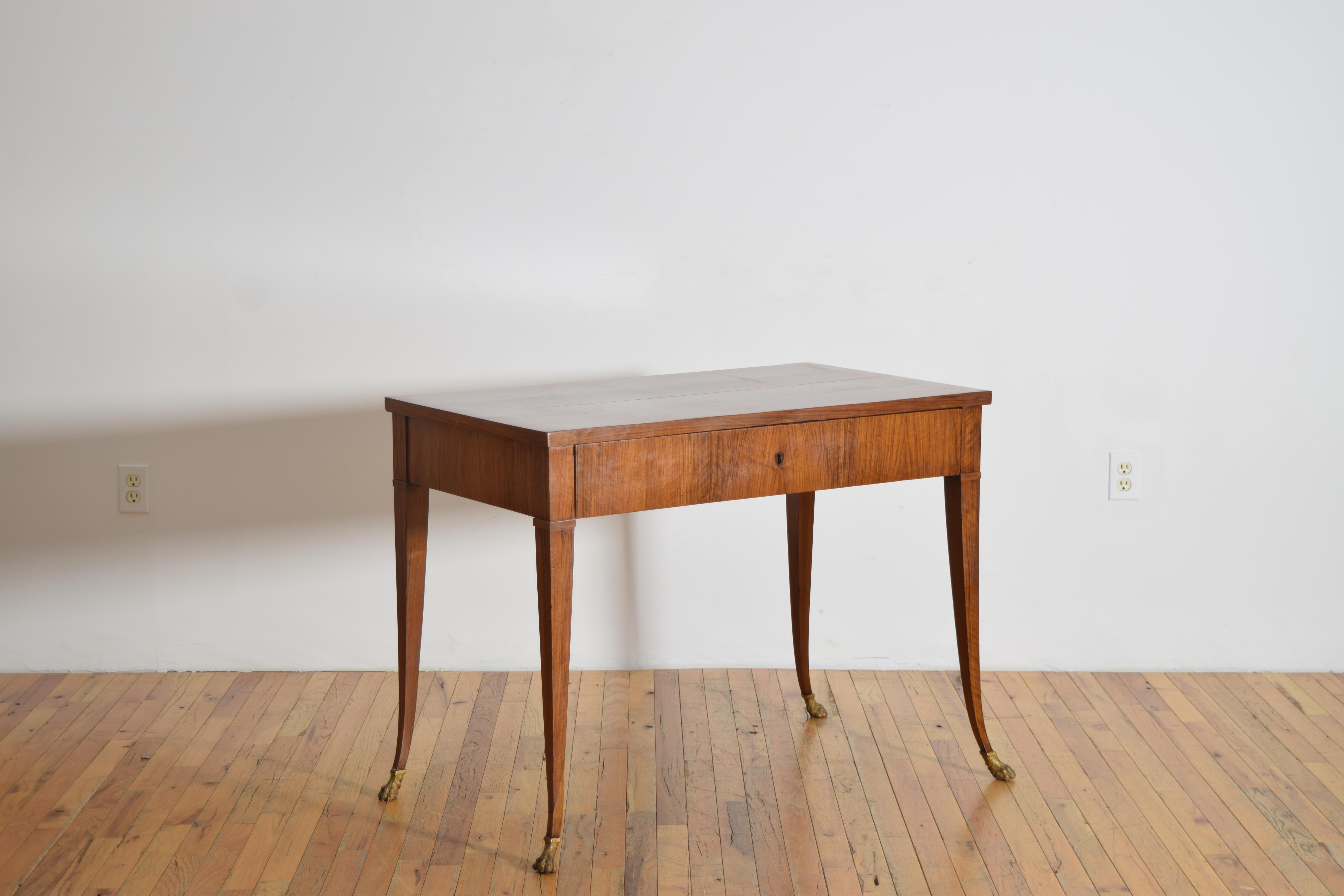 having a rectangular top above a case housing one drawer with a sliding leather writing surface within, below the leather slide is an interior with drawers and storage, the case raised on elegantly splayed legs ending in carved paw feet, width and