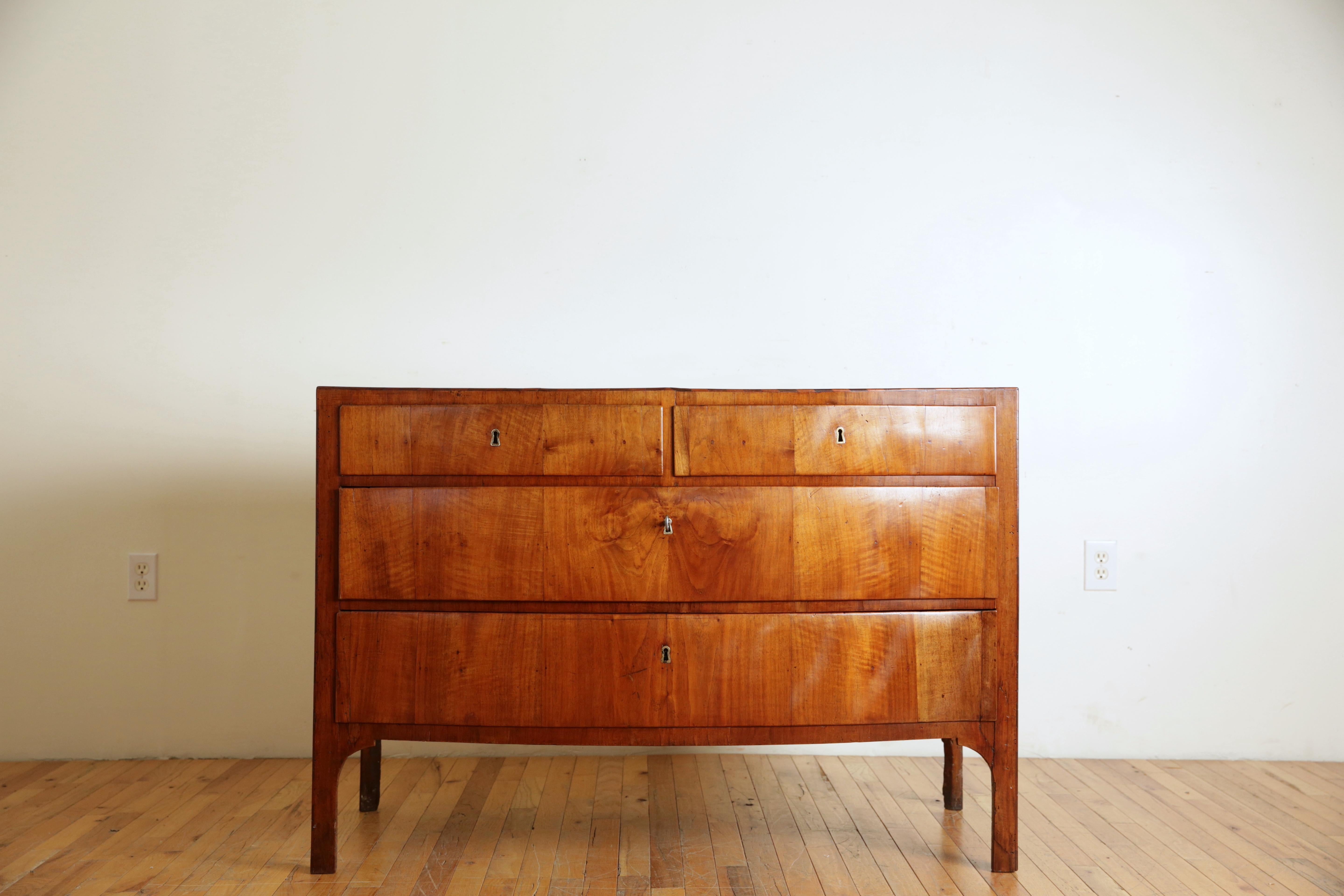 certainly inspired by the later English Georgian periods this bowfront chest is unique in that the bow actually straightens out near its widest points, the shaped top and conforming case housing two smaller drawers over two larger drawers are