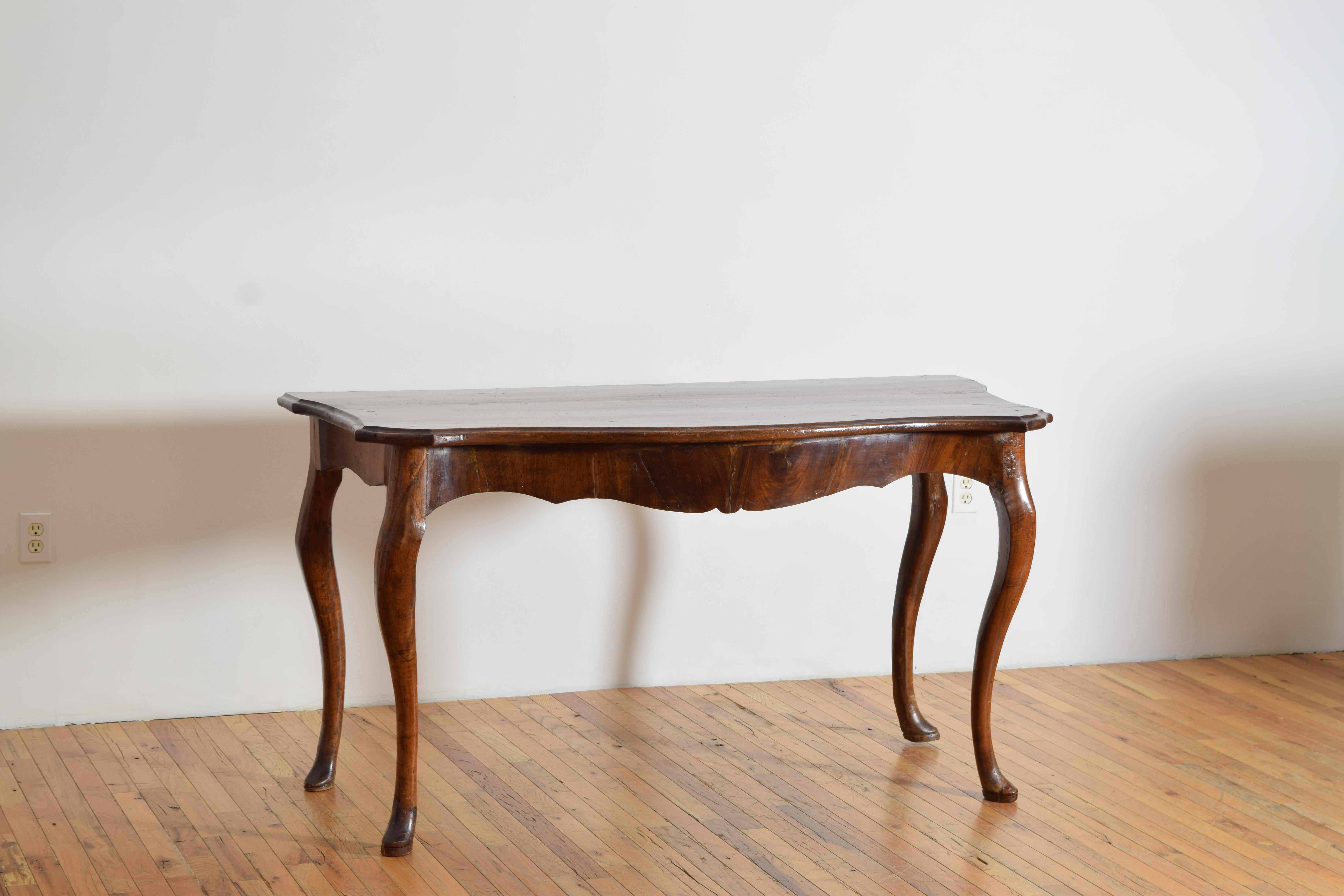 Having a classically serpentine shaped top and curved sides above a uniquely shaped apron, the cabriole legs gracefully appointed and ending in pad feet