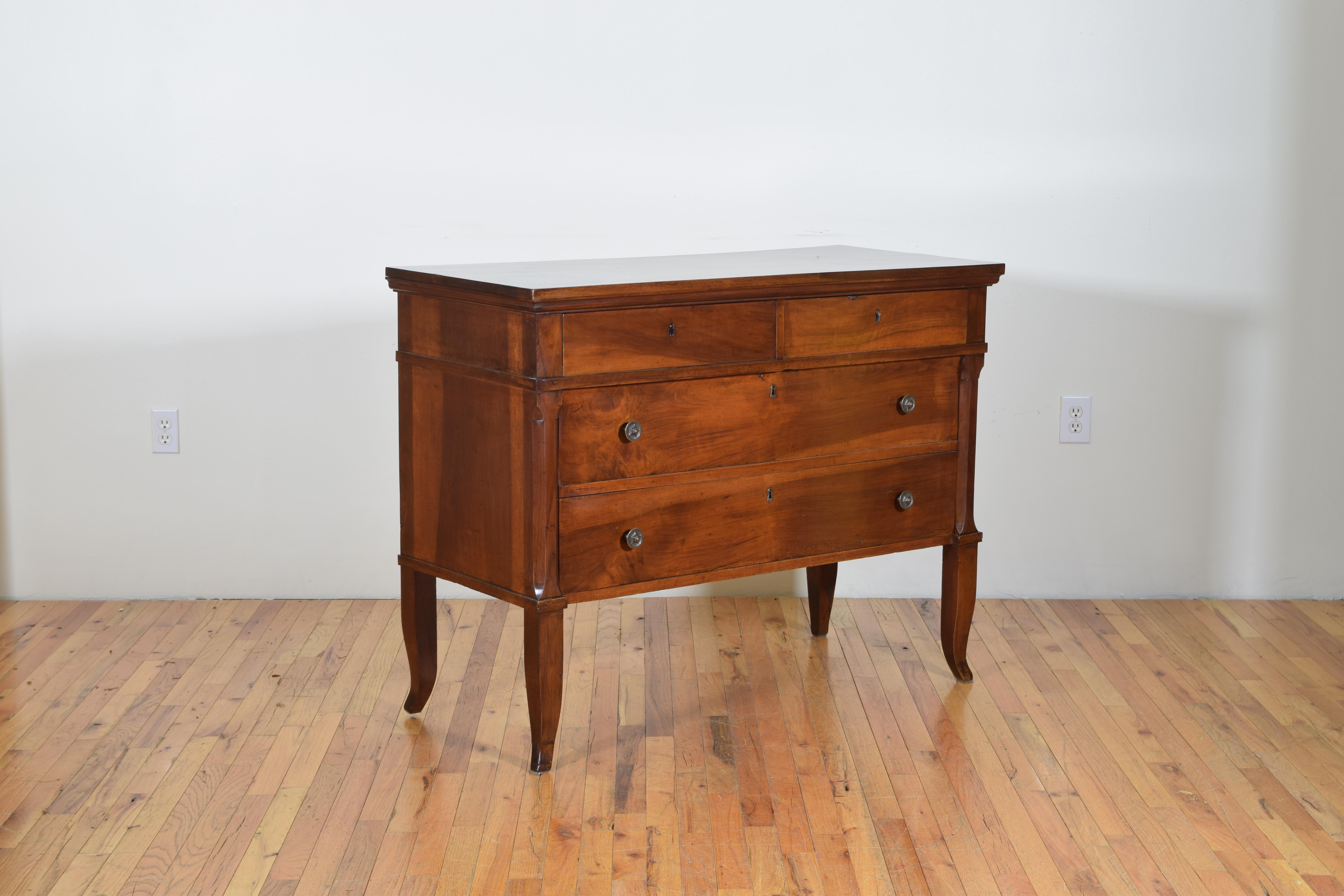 Constructed of solid walnut and poplar as a secondary (interior) wood this commode has a rectangular top above a conforming case housing two small drawers over two larger drawers, the front corners of the commode are slightly tapered inward, raised