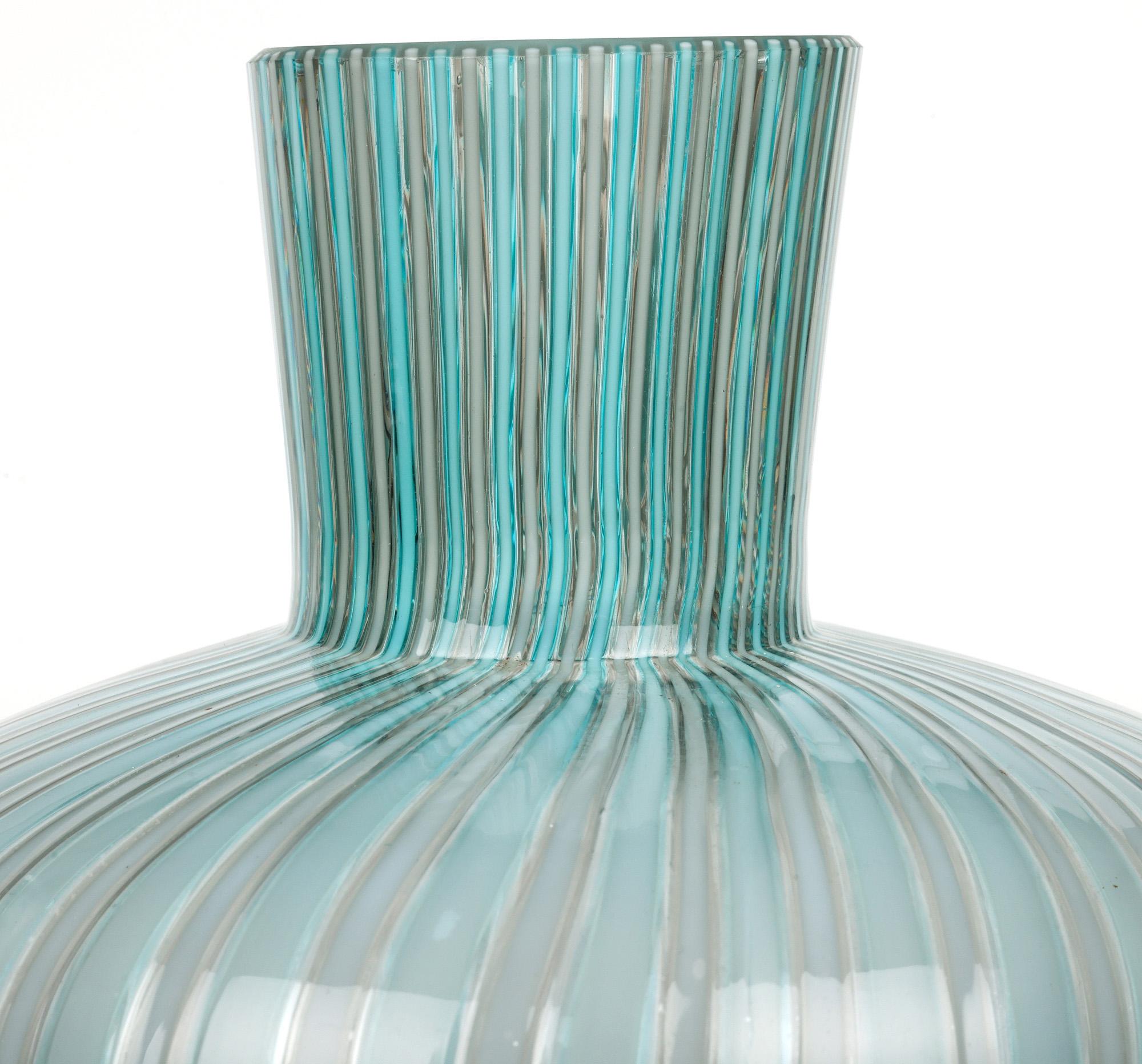 A very stylish Italian mid-century mezza filigrana waisted tall art glass vase attributed to Venini and probably dating from around 1960 but possibly earlier. The hand-blown glass vase stands on a wide skirted foot with the fine-colored threads